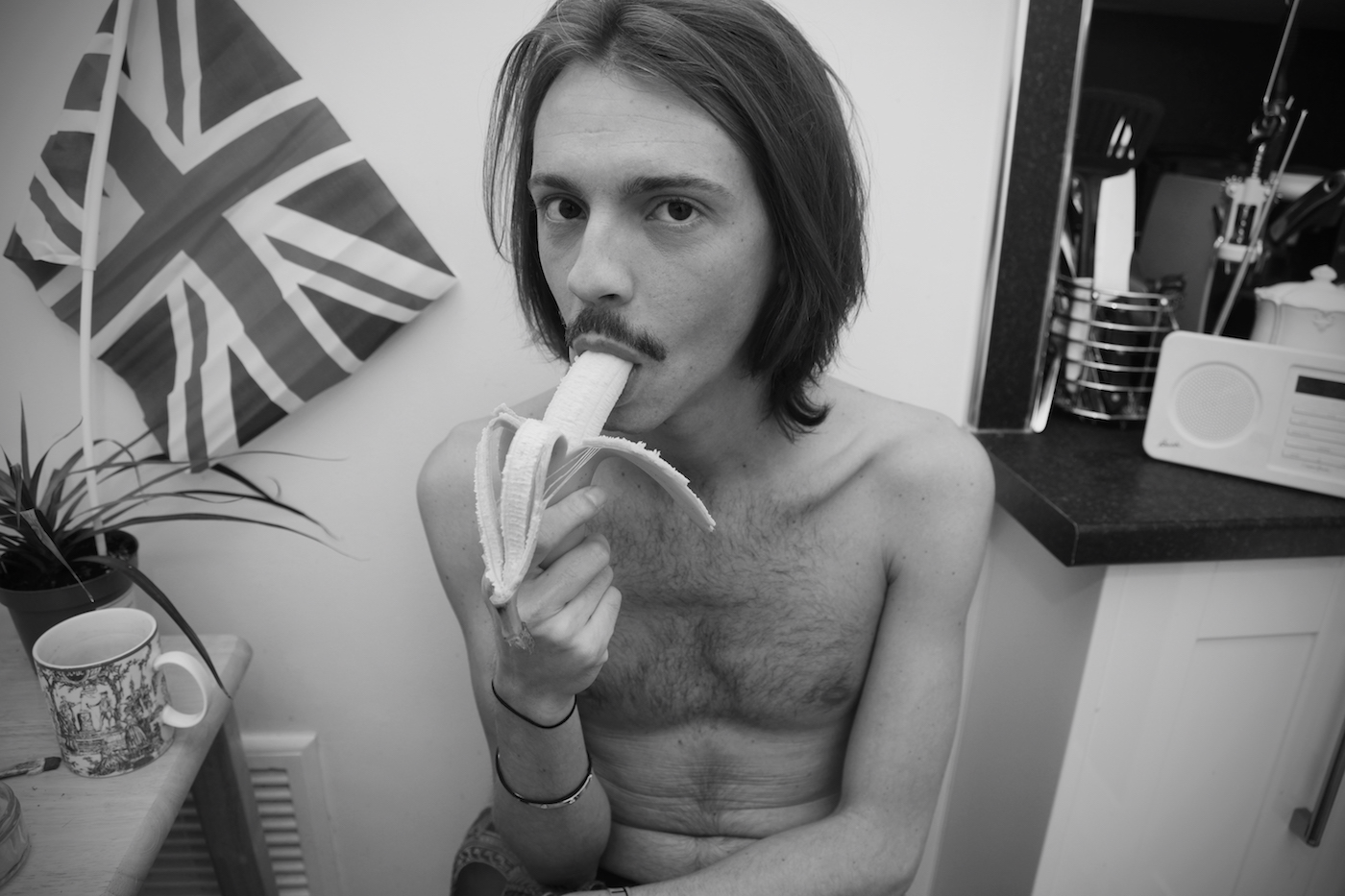 black and white photo of man eating a banana black and white photo of a person a bed in a nightgown - Poem Baker photography “Hymns From the Bedroom.”