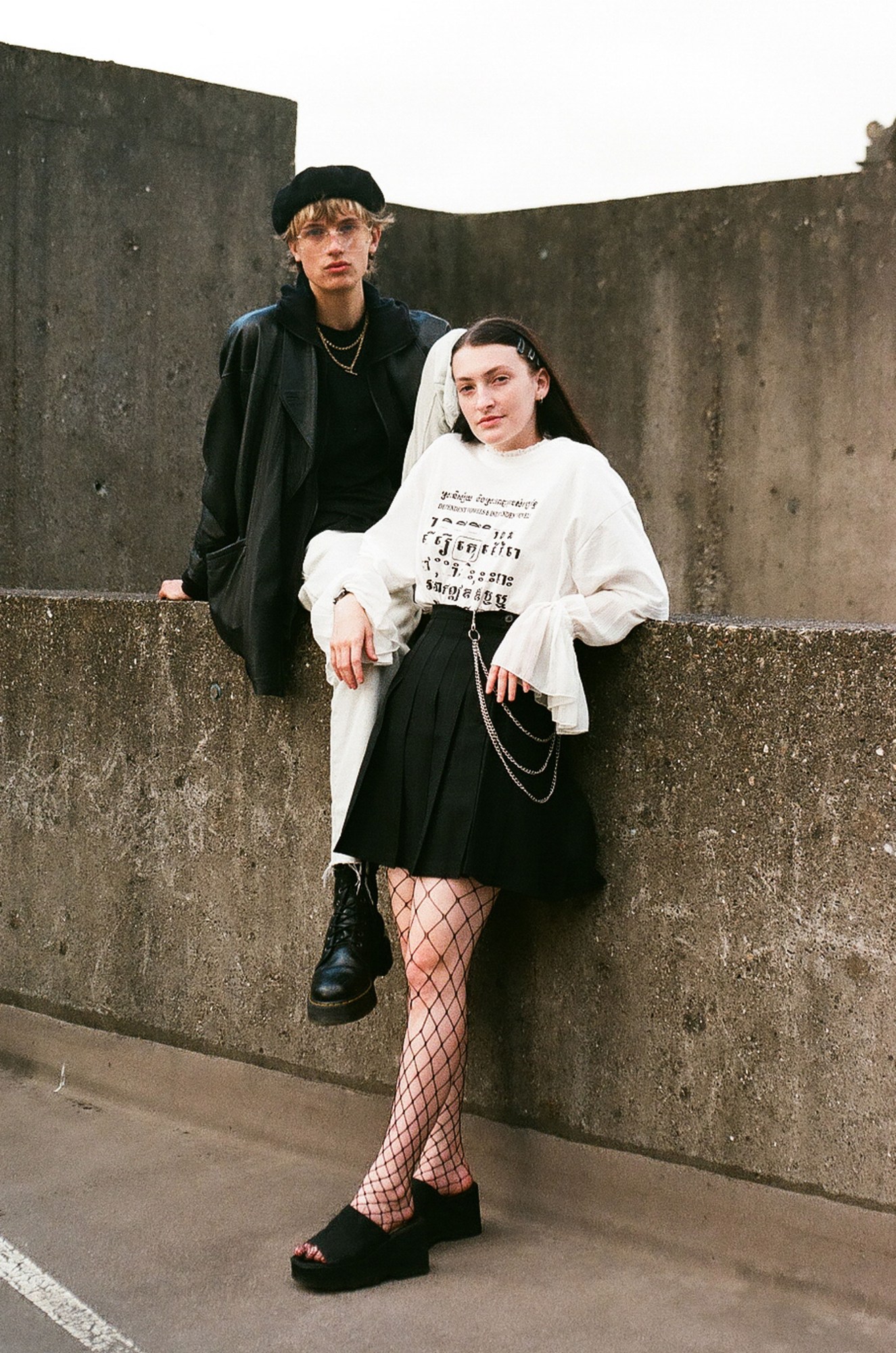 Newcastle youth photography: a couple standing and sitting on concrete walls