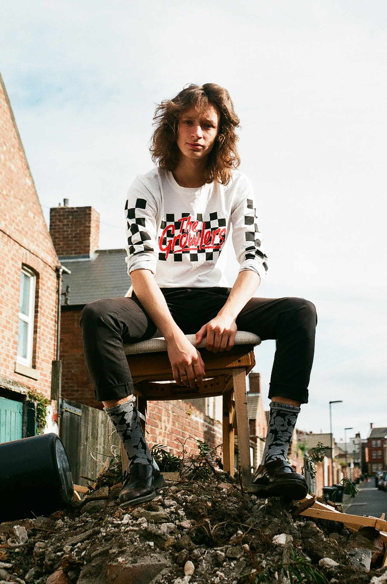 Newcastle youth photography: a man sitting on a chair in some rubble