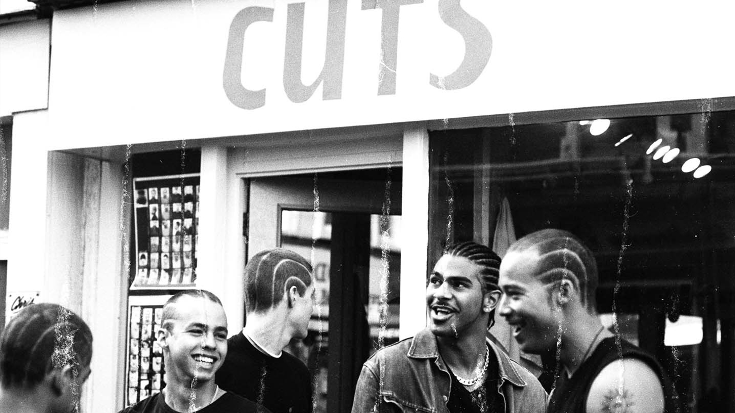 Group of men hang out outside cult London salon Cuts