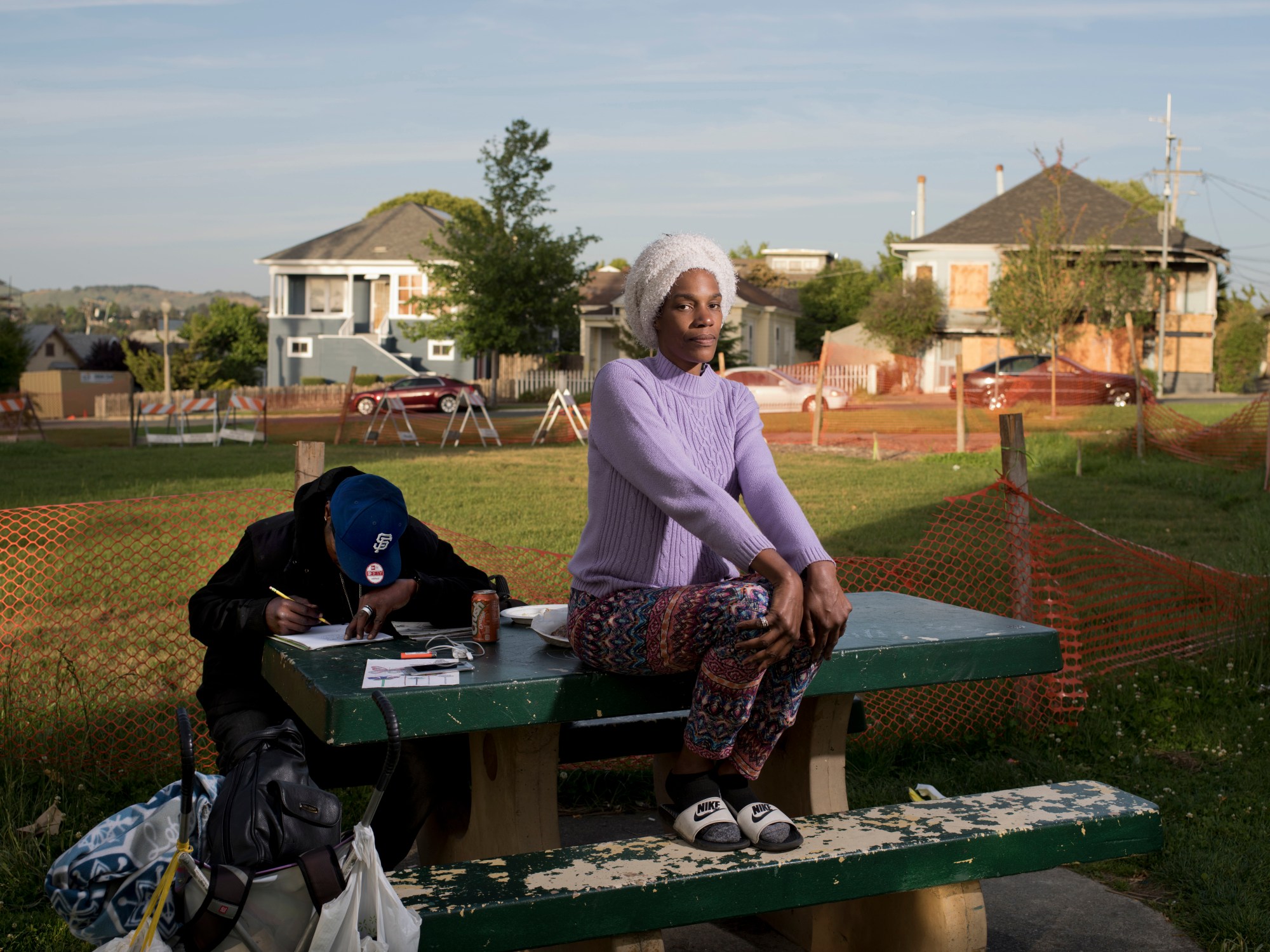 Carolyn Drake photographs a woman sat on a bench