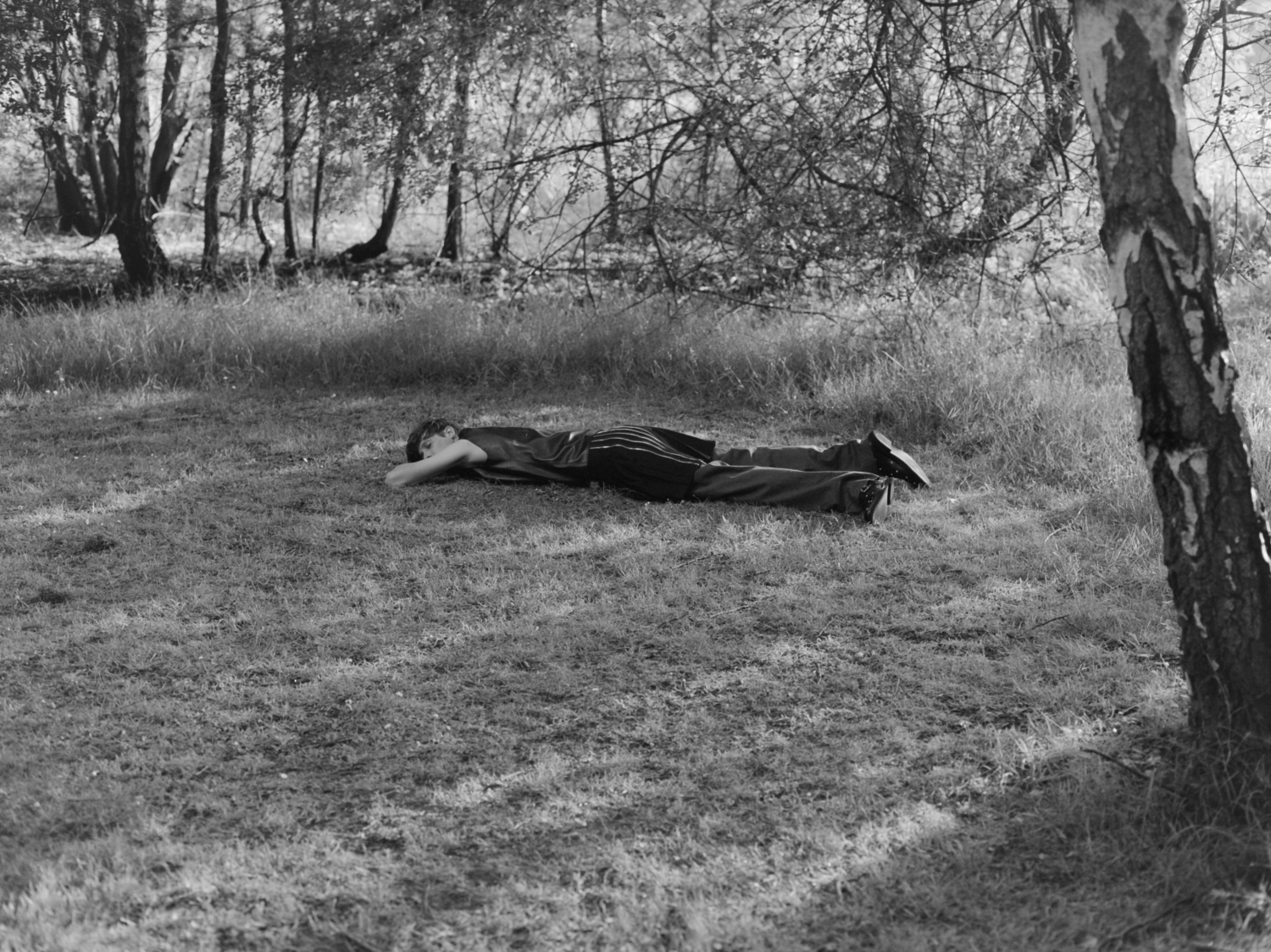 yann faucher photographs a model lying in the woods