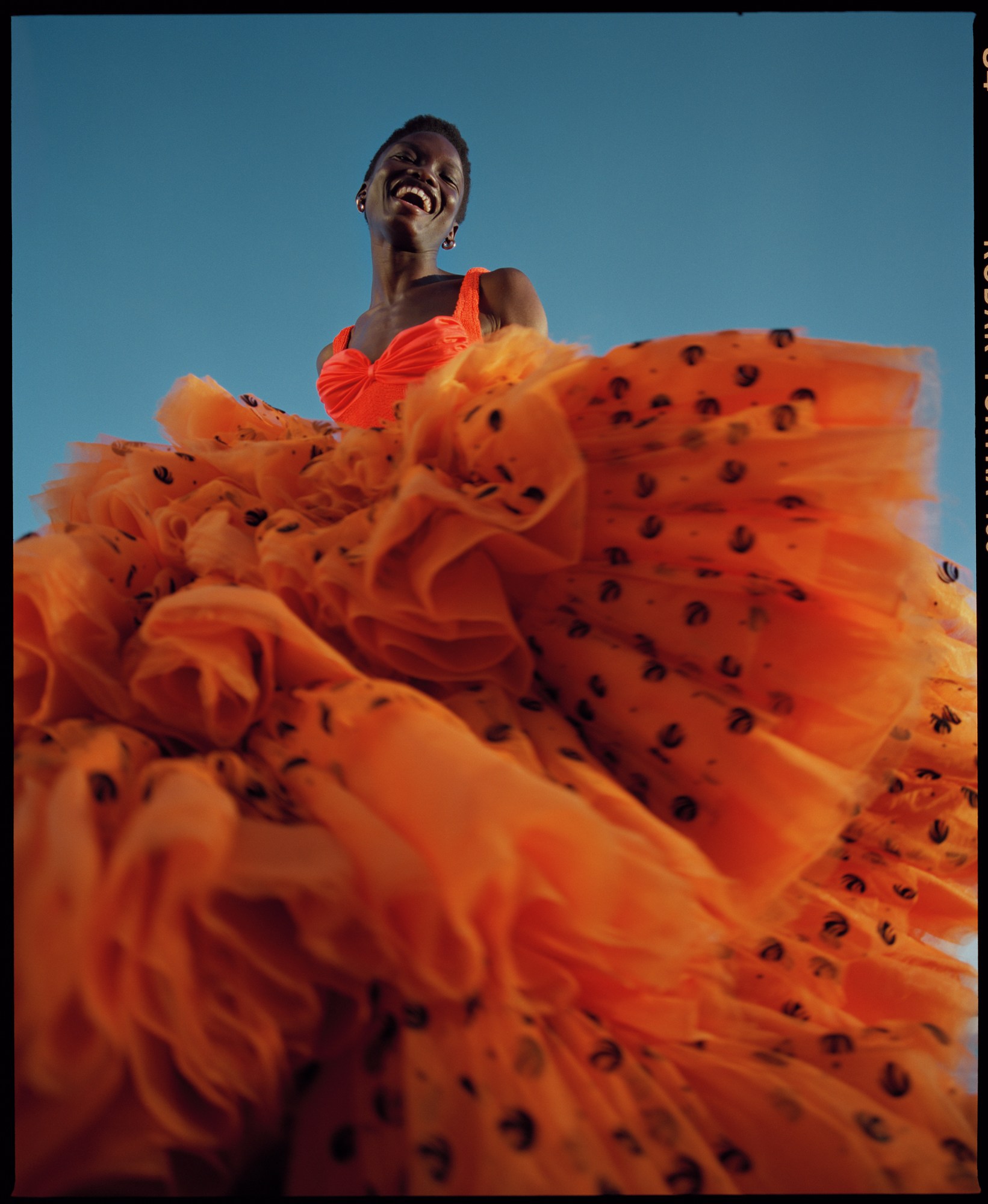 nadine ijewere photographs a model laughing at the beach