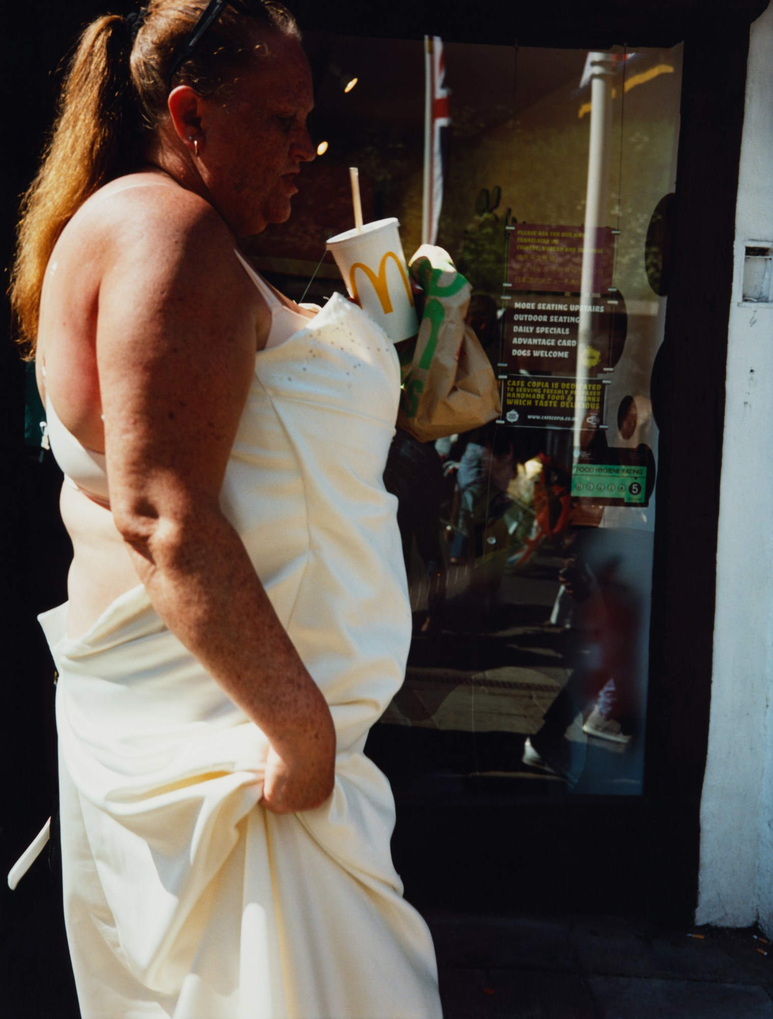 maxwell tomlinson photographs a woman in a white dress with mcdonalds