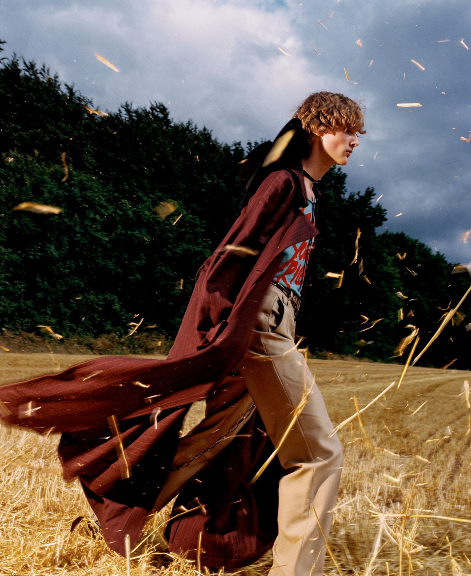 model in a field of hay