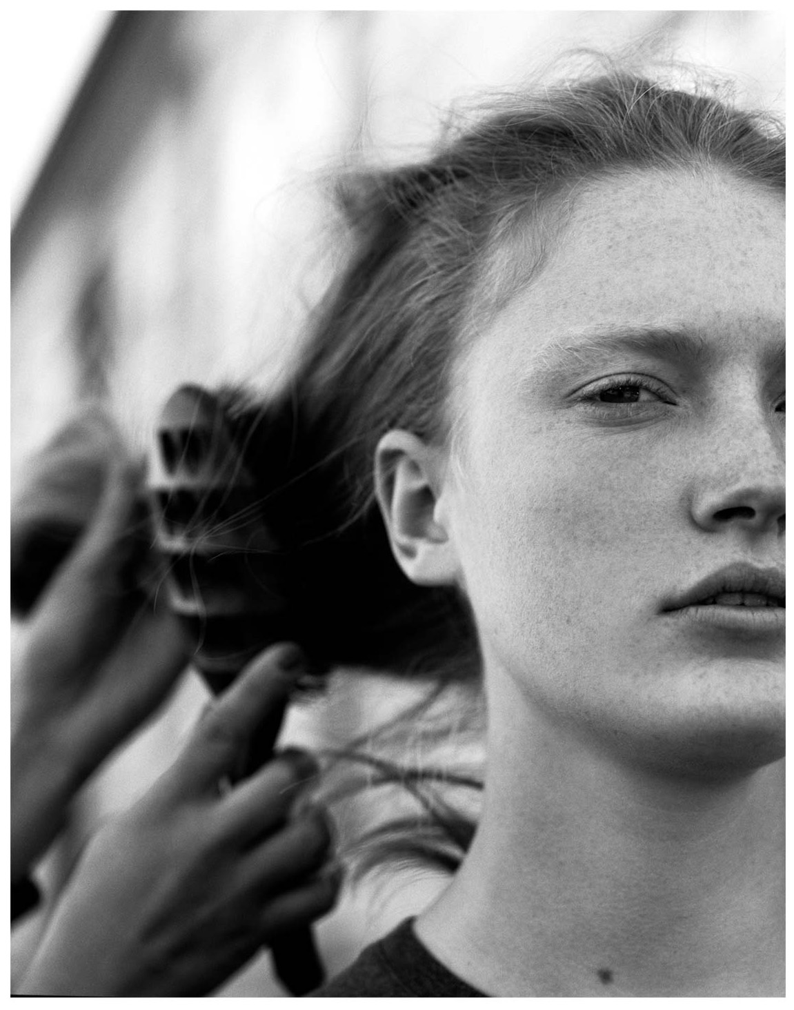 model having her hair brushed