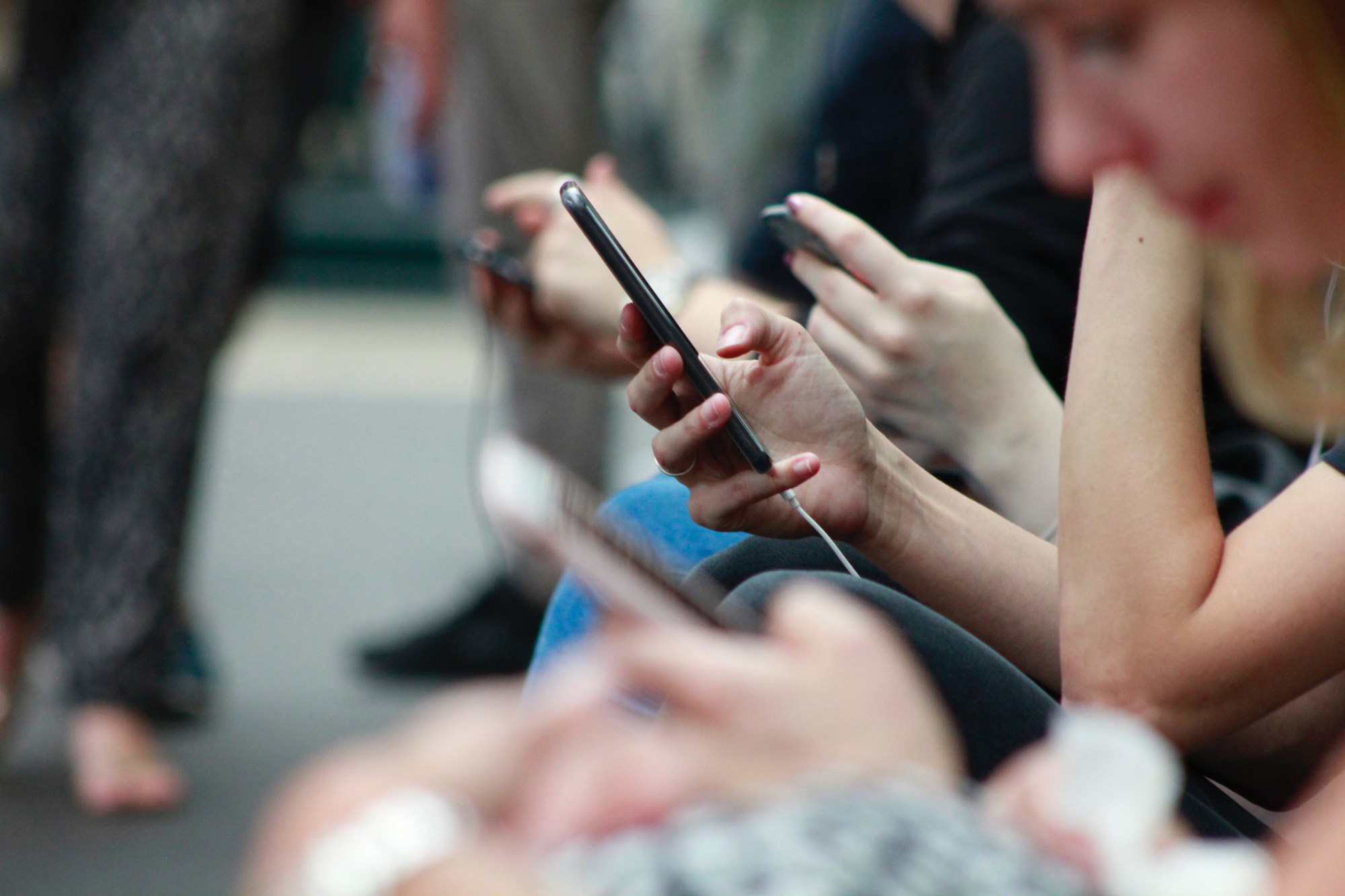 People using their phones on a train