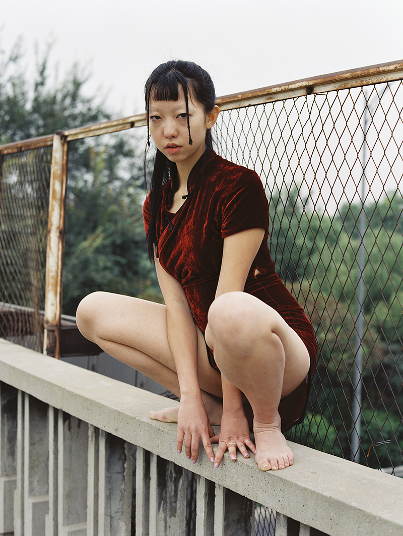 luo yang photographs a girl sat on a bridge