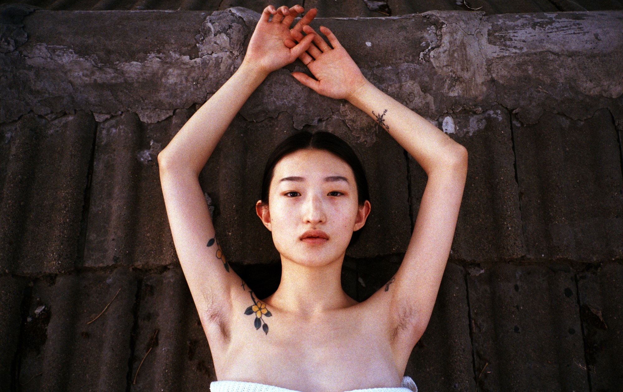 luo yang photographs a woman with her hands in the air