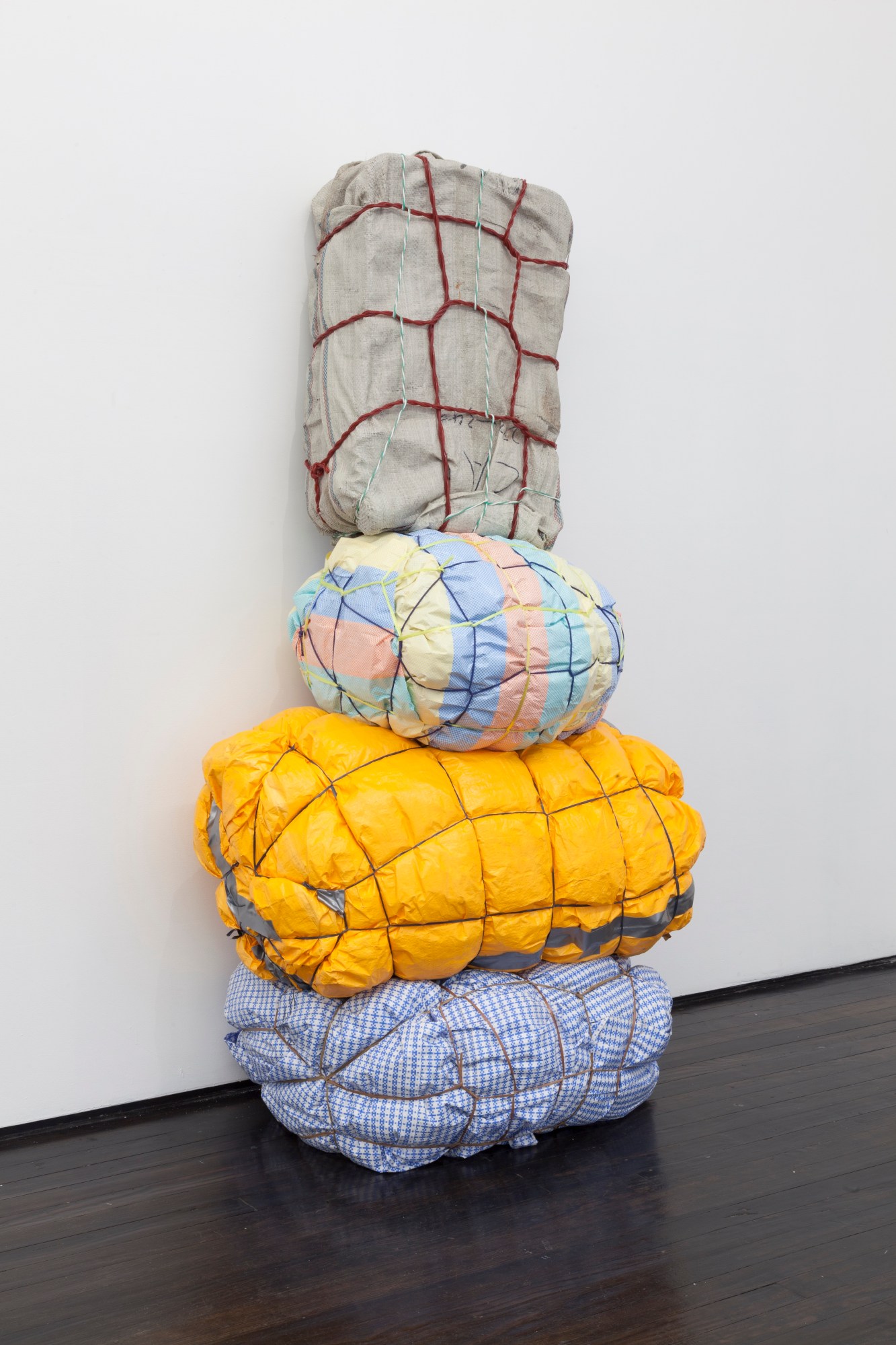 Maia Ruth Lee, Bondage Baggage Prototype 4, 2018. Tarp, rope, tape, luggage, used clothing, and bedding, 67 x 35 x 21 in. (170.2 x 88.9 x 53.3 cm). Image courtesy the artist and Jack Hanley Gallery, New York. Photograph by Brad Farwell