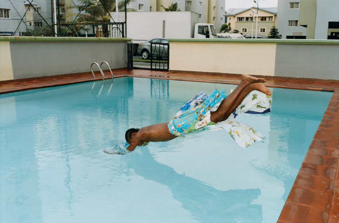 Man jumps into swimming pool