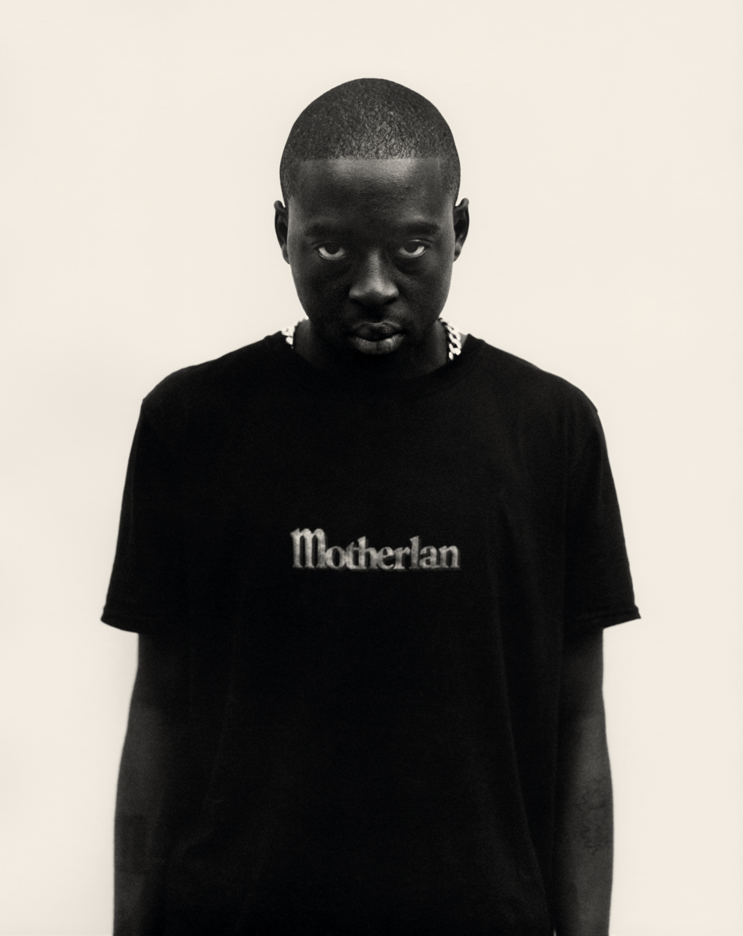 Man in Motherlan t-shirt, shot in black and white