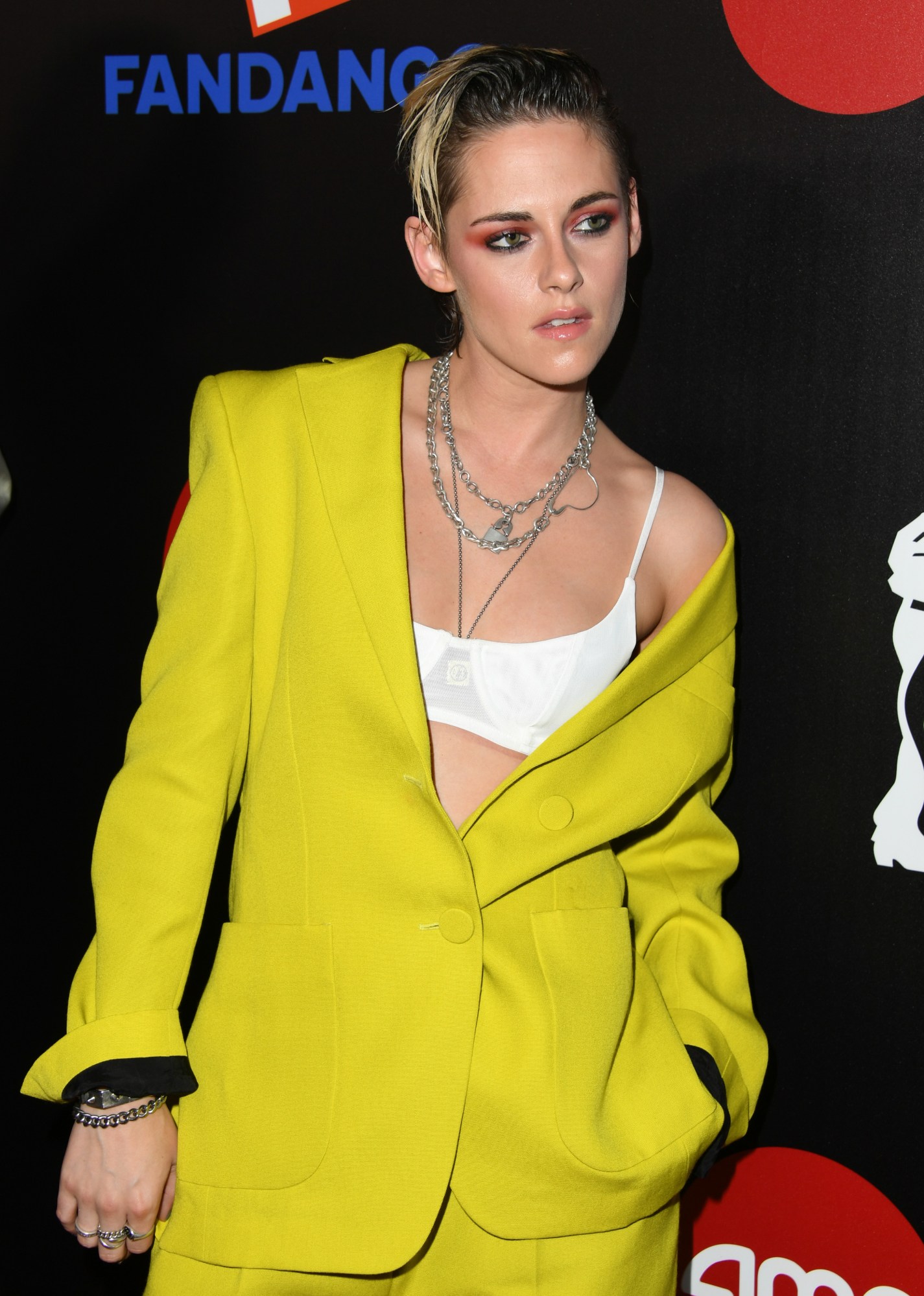 Kristen Stewart on the red carpet in a yellow suit