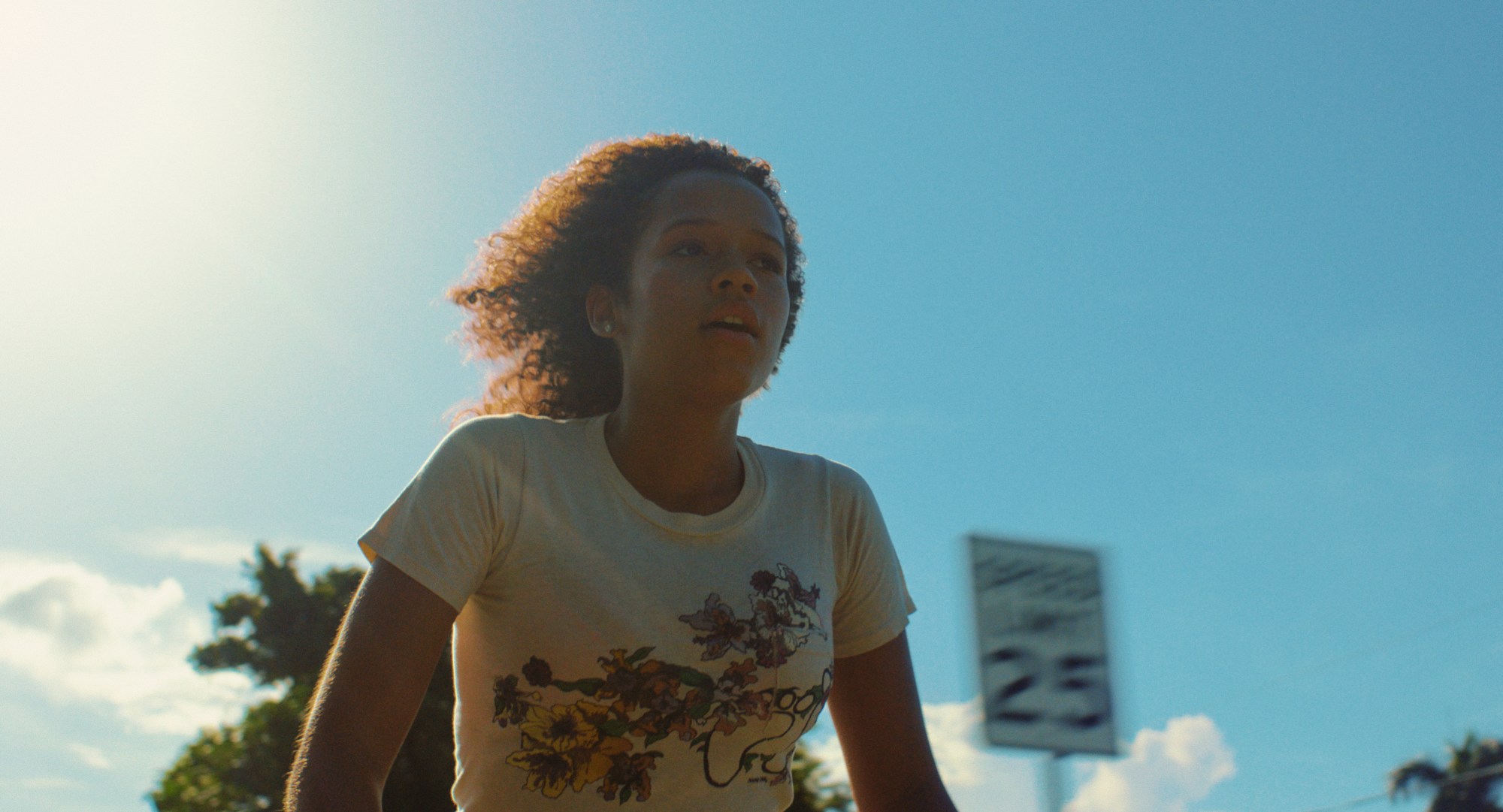 Taylor Russell riding a bike in the film Waves