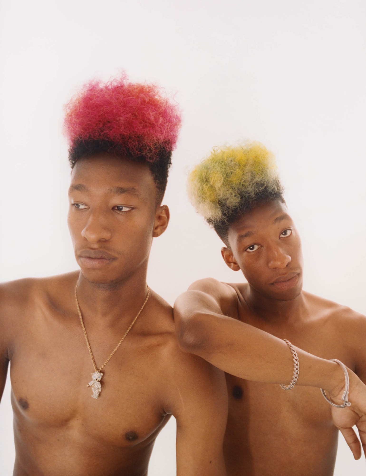 Two men with pink and yellow mohawks
