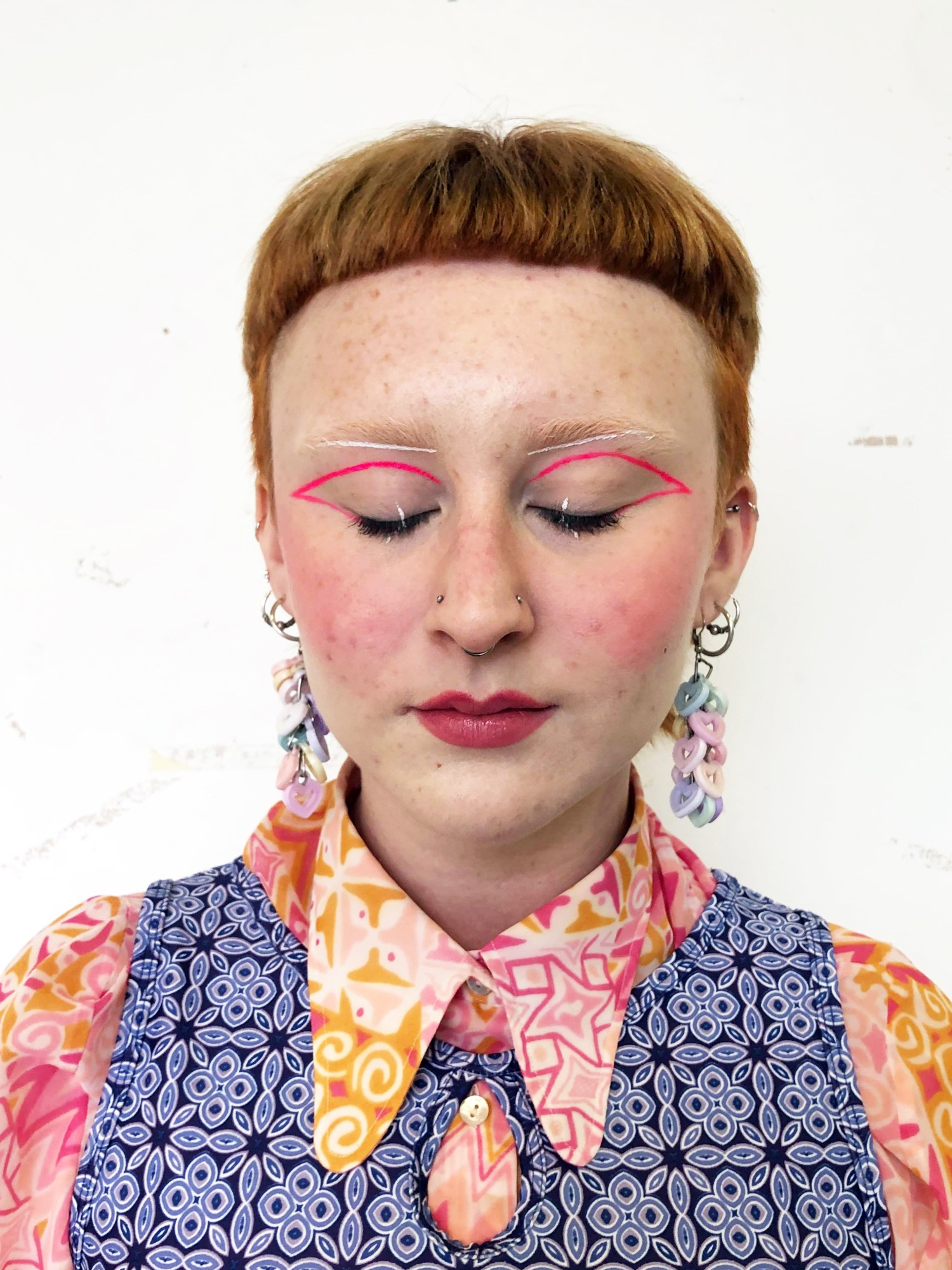 a girl wearing eye makeup for fester newspaper