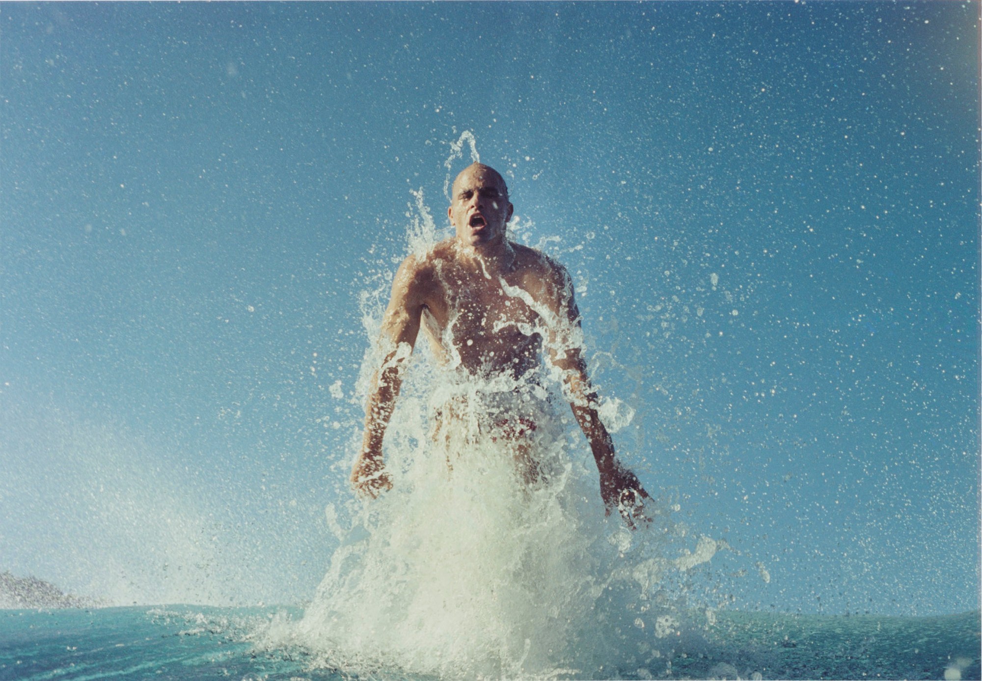 Surfer jumping out of the water