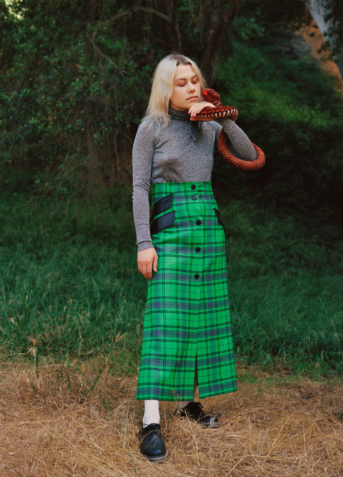 Phoebe Bridgers holding a snake, shot by Daria Kobayashi Ritch for i-D