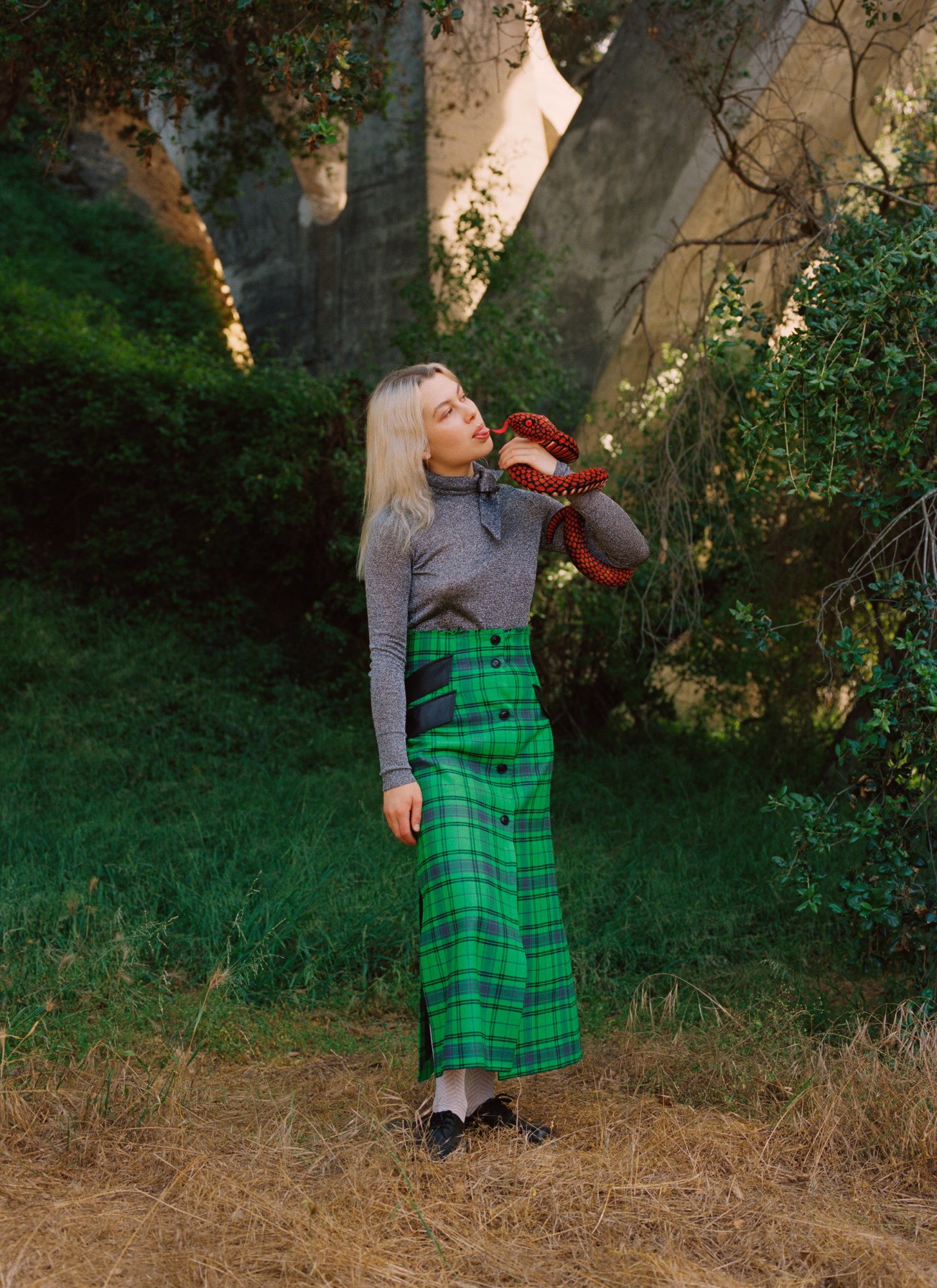 Phoebe Bridgers holding a snake, shot by Daria Kobayashi Ritch for i-D