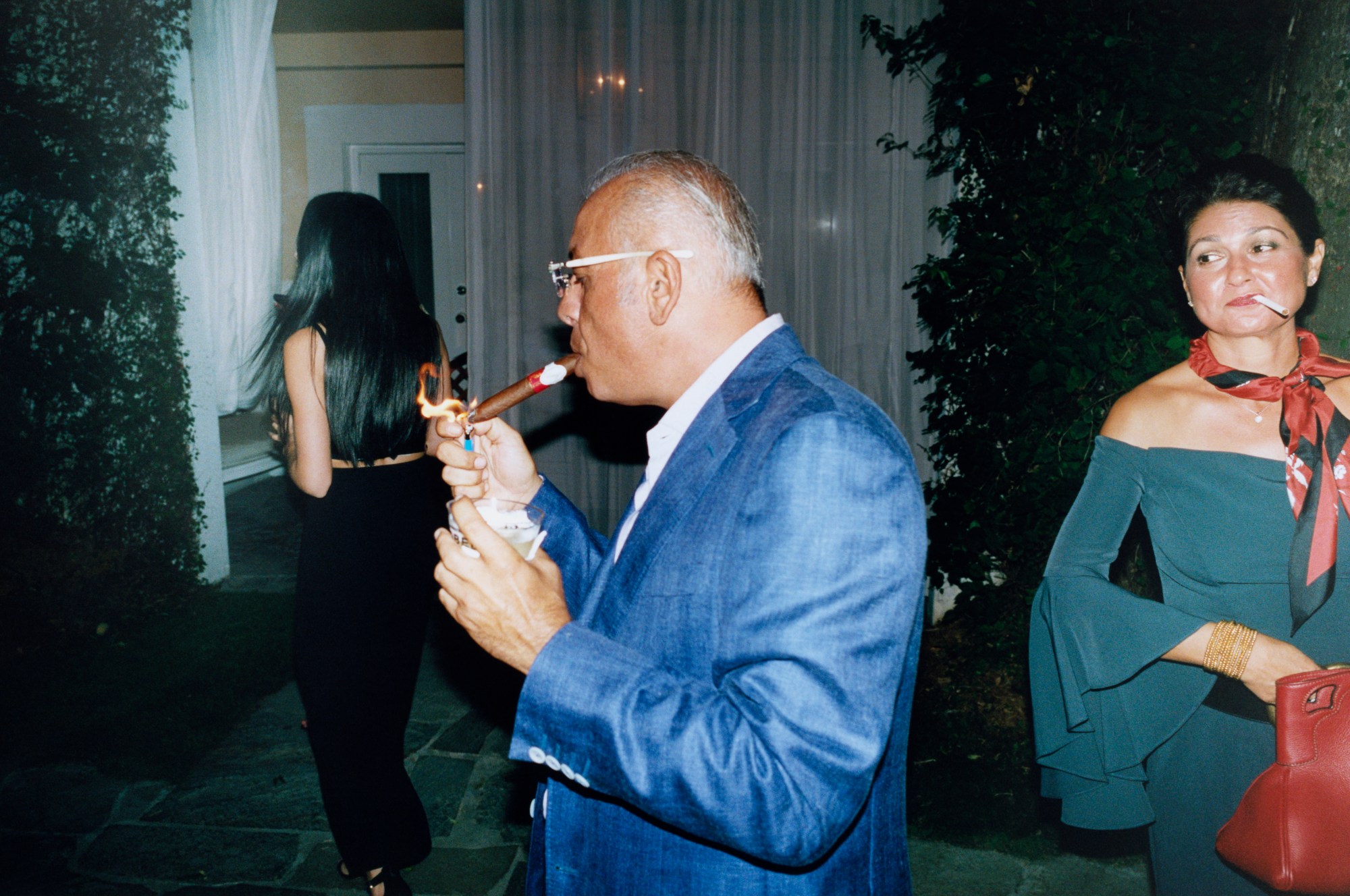 a man smoking a cigar at art basel