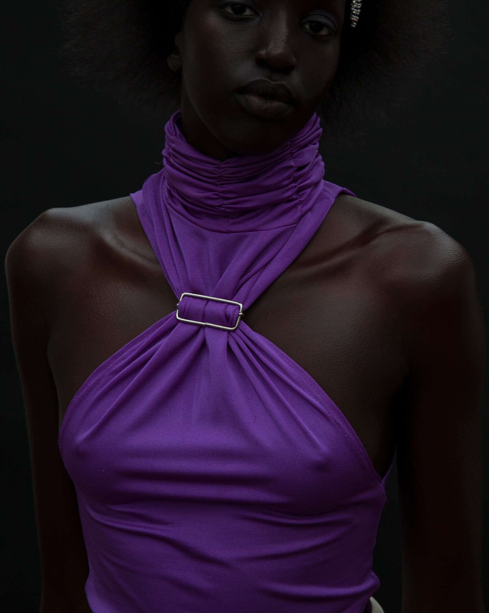 a model wearing a purple top