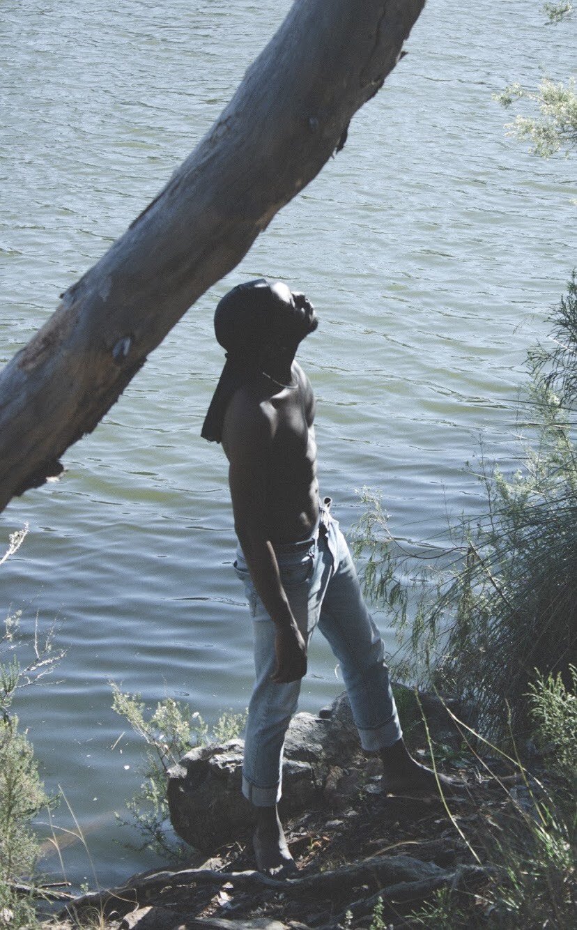 a man standing on the edge of a lake