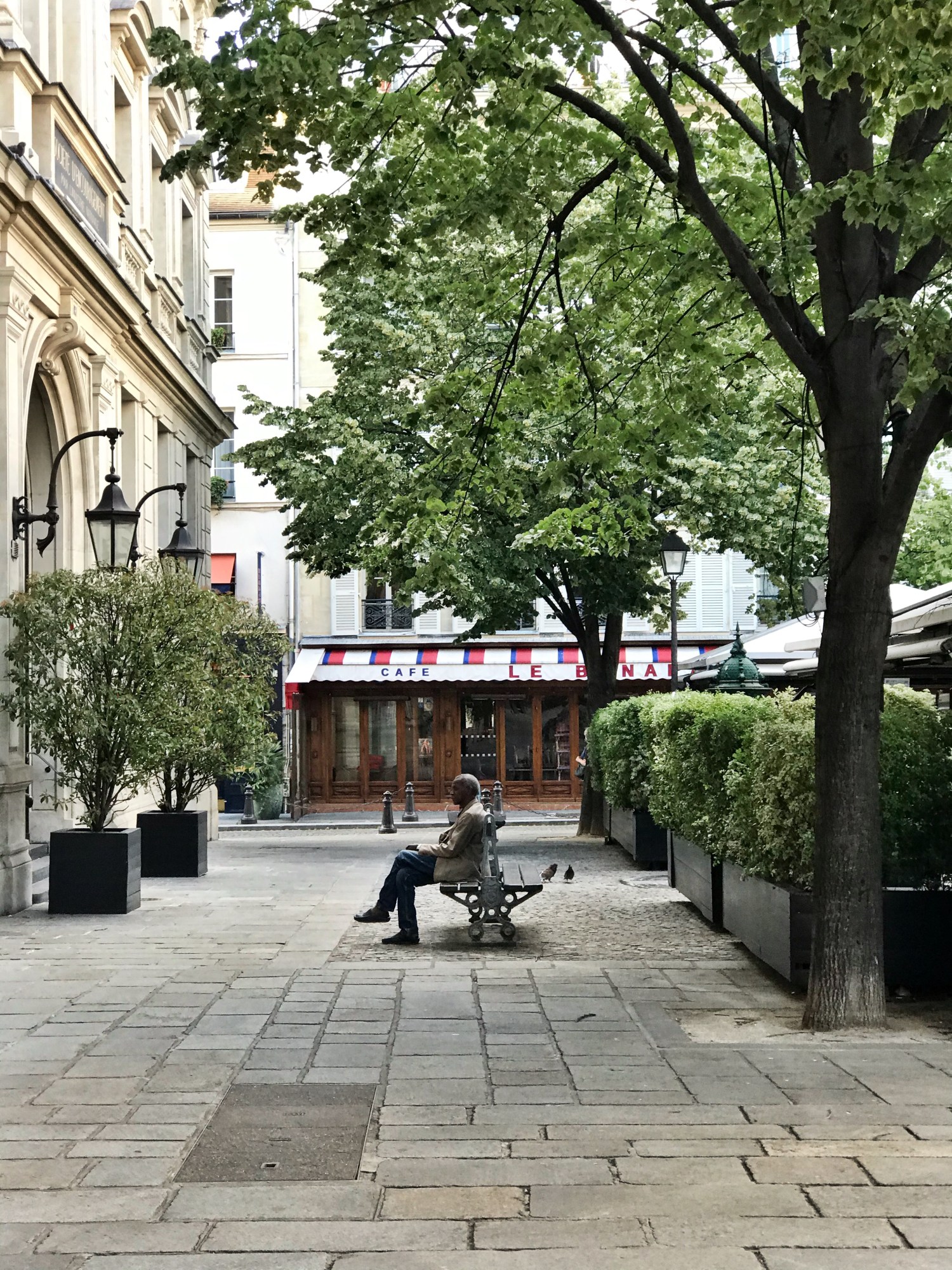 a man sitting on a bench in paris