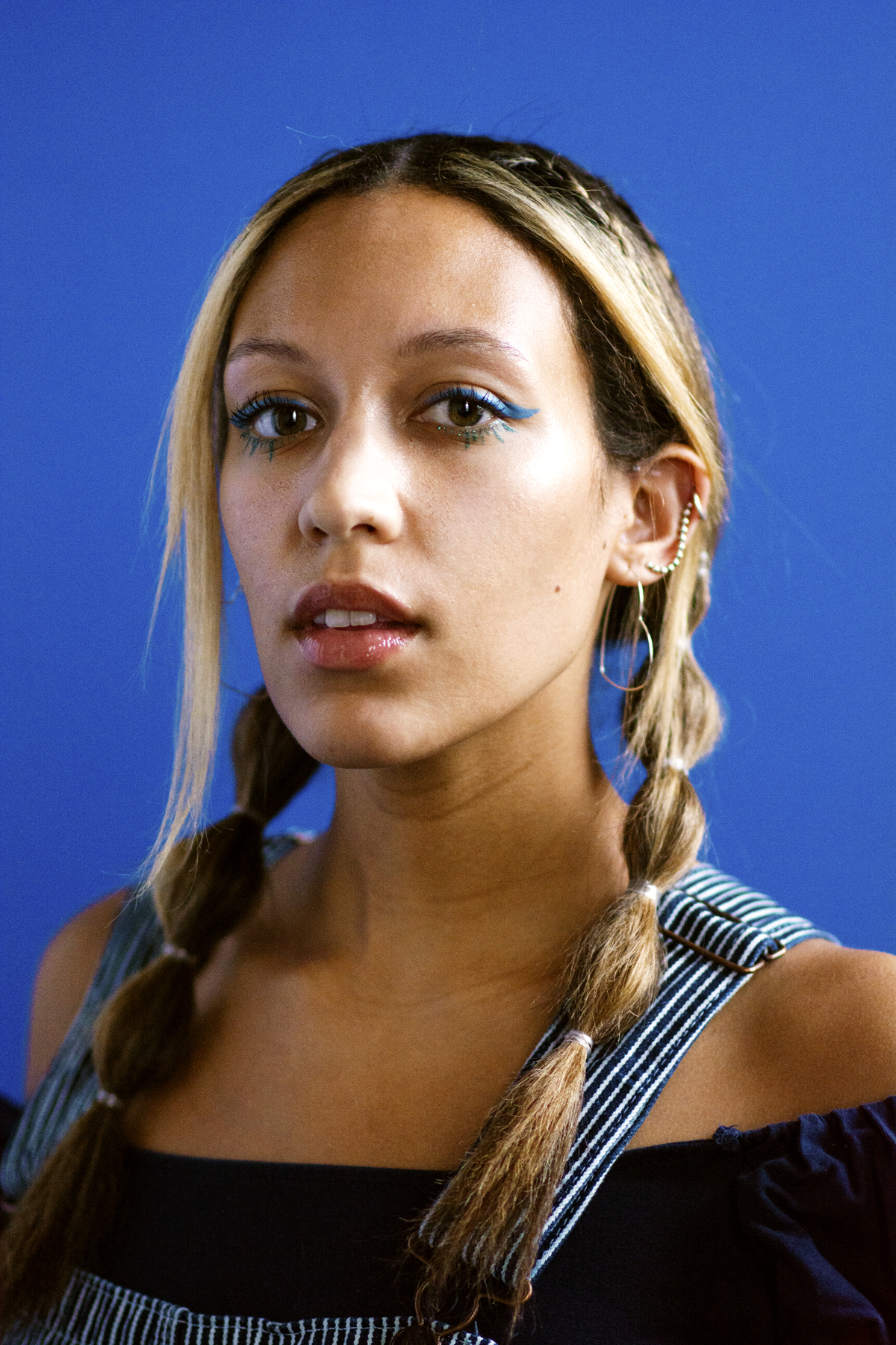 Woman in blue striped dungarees. Photographed by Marcus Branch.