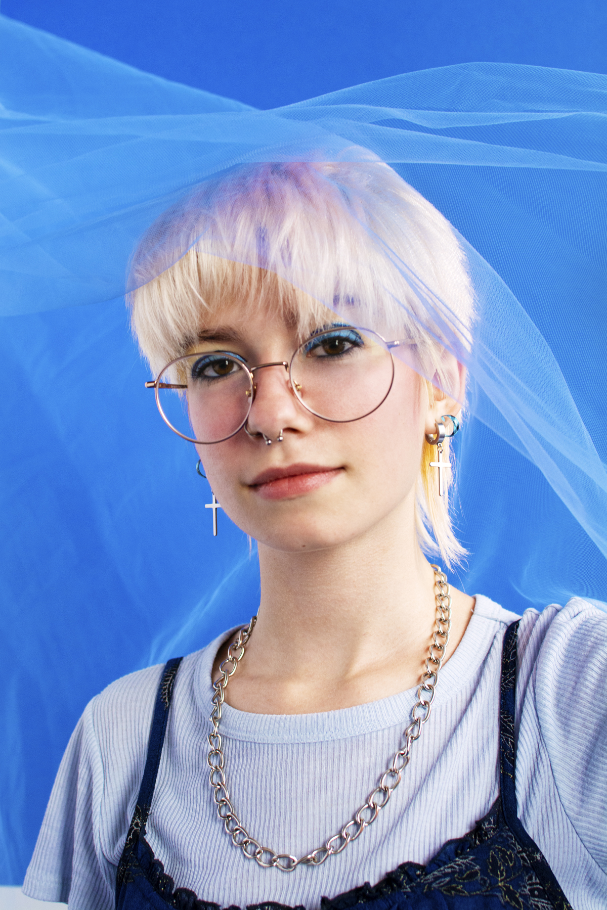 Woman with a white t-shirt, floral blue camisole and silver chain. Photographed by Marcus Branch.