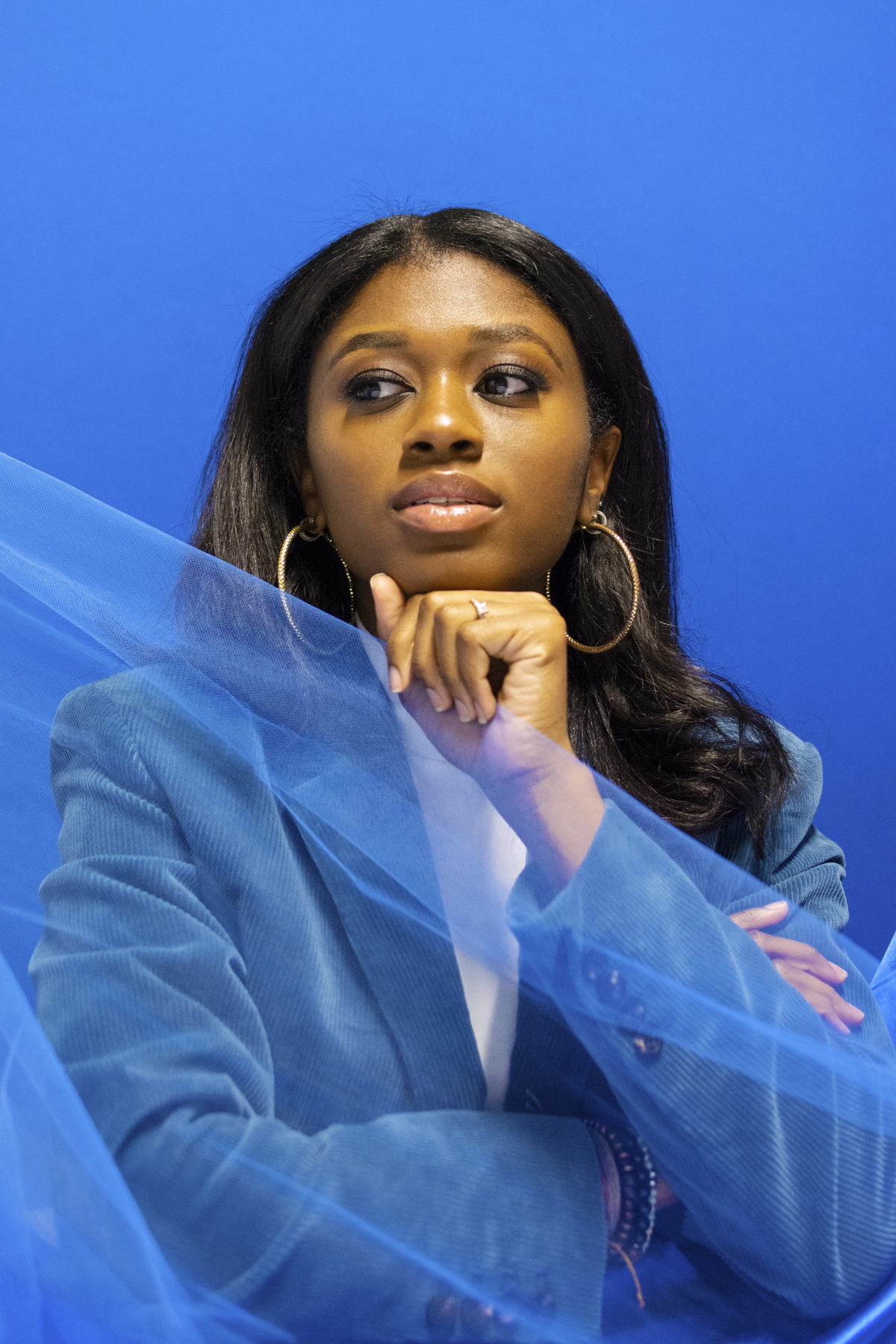 Woman with a white t-shirt and blue corduroy blazer. Photographed by Marcus Branch.