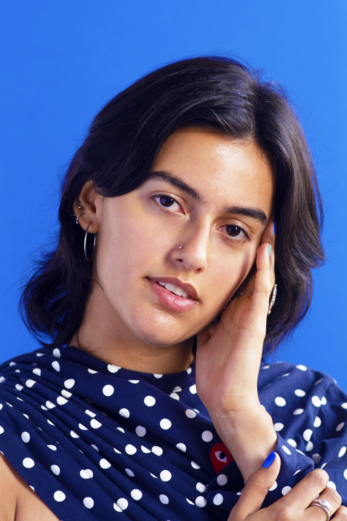 Woman with a blue Commes Des Garçon polka dot shawl. Photographed by Marcus Branch.