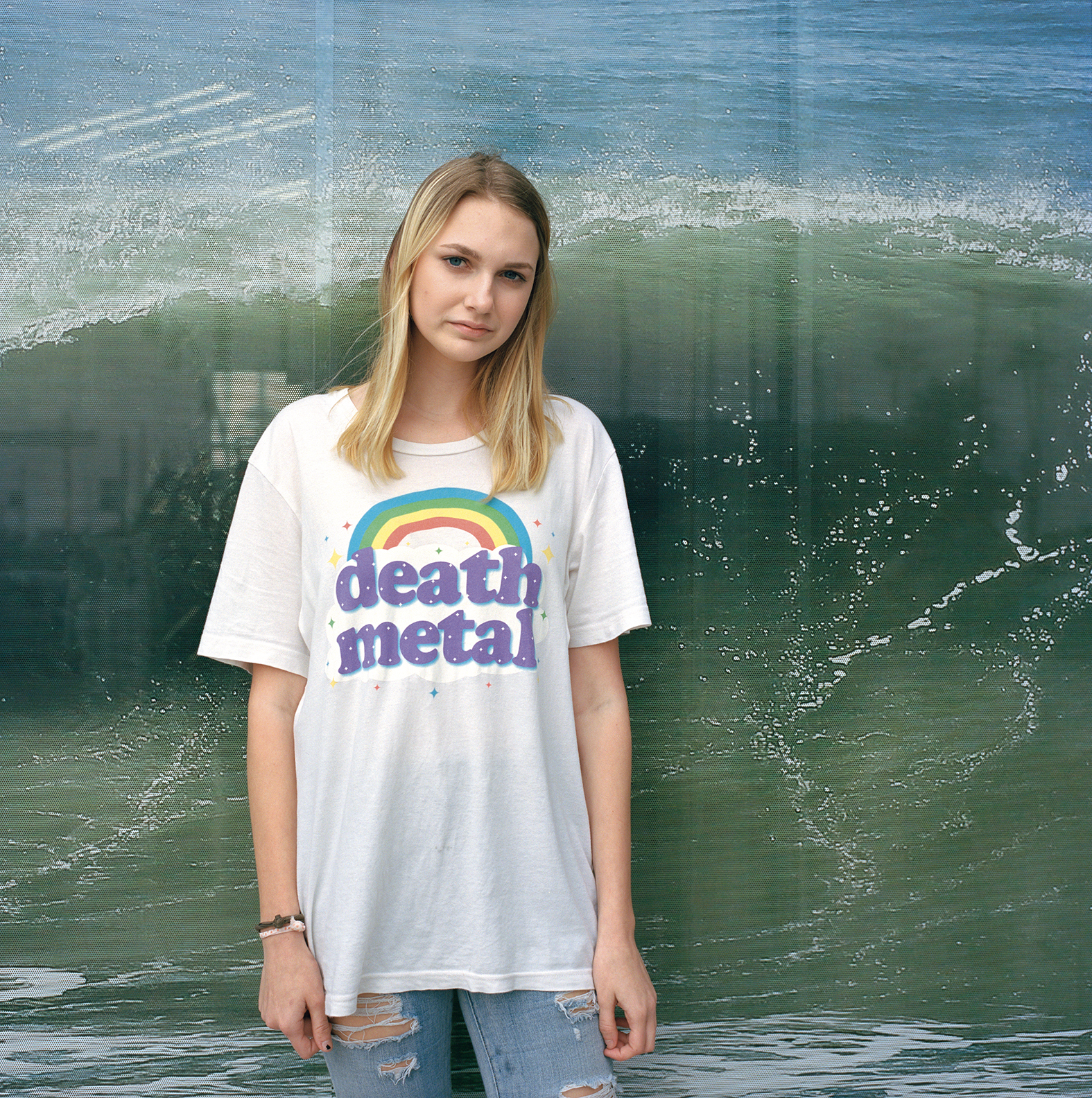 a woman in a t-shirt with a rainbow on it that says death metal by deanna templeton