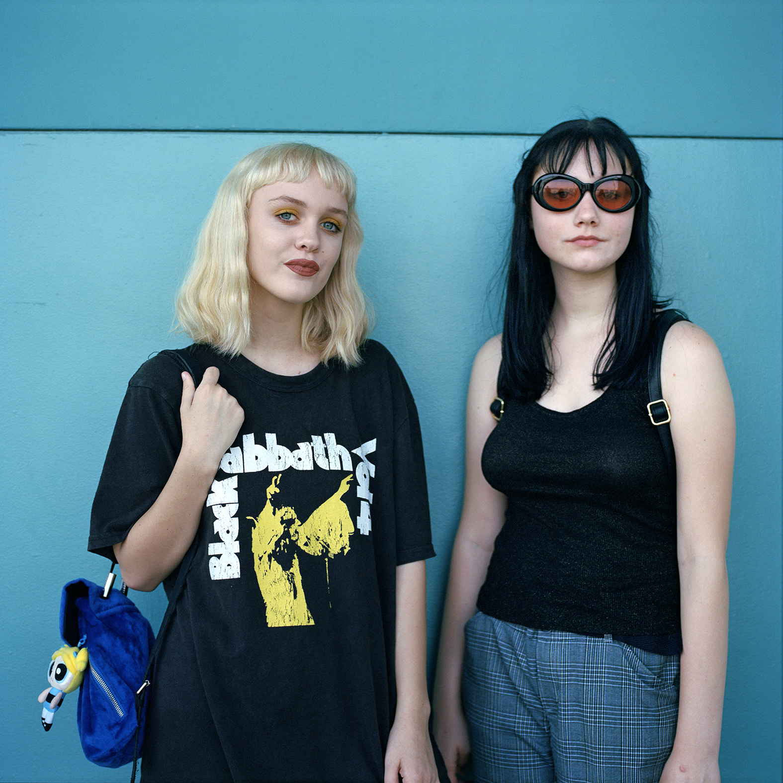 two women, one wearing a black sabbath t-shirt by deanna templeton