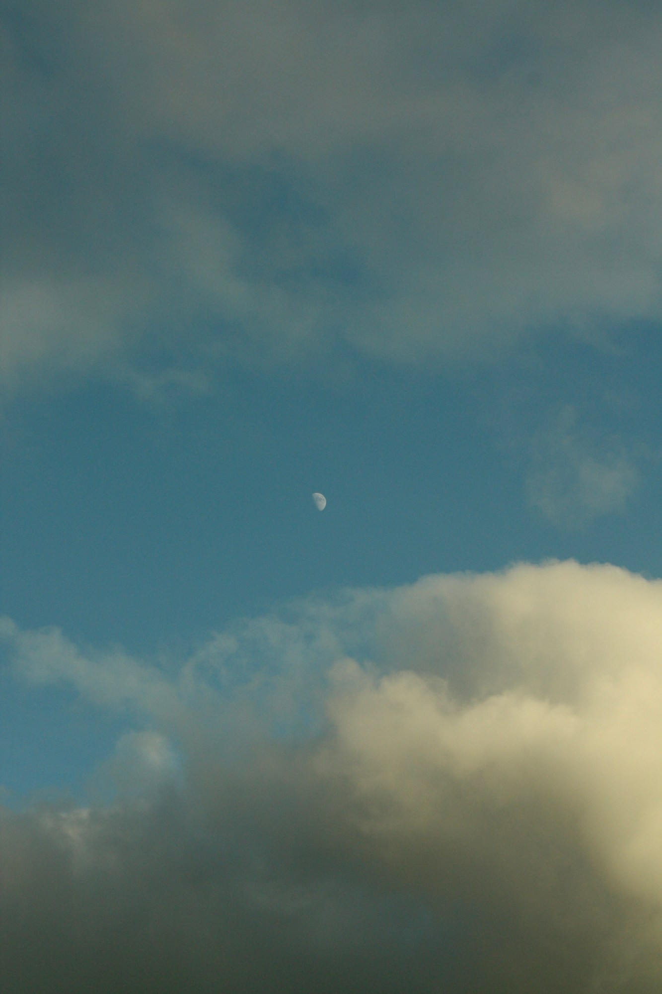 the moon behind clouds