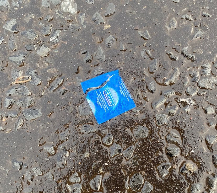 a condom wrapper lying on the floor