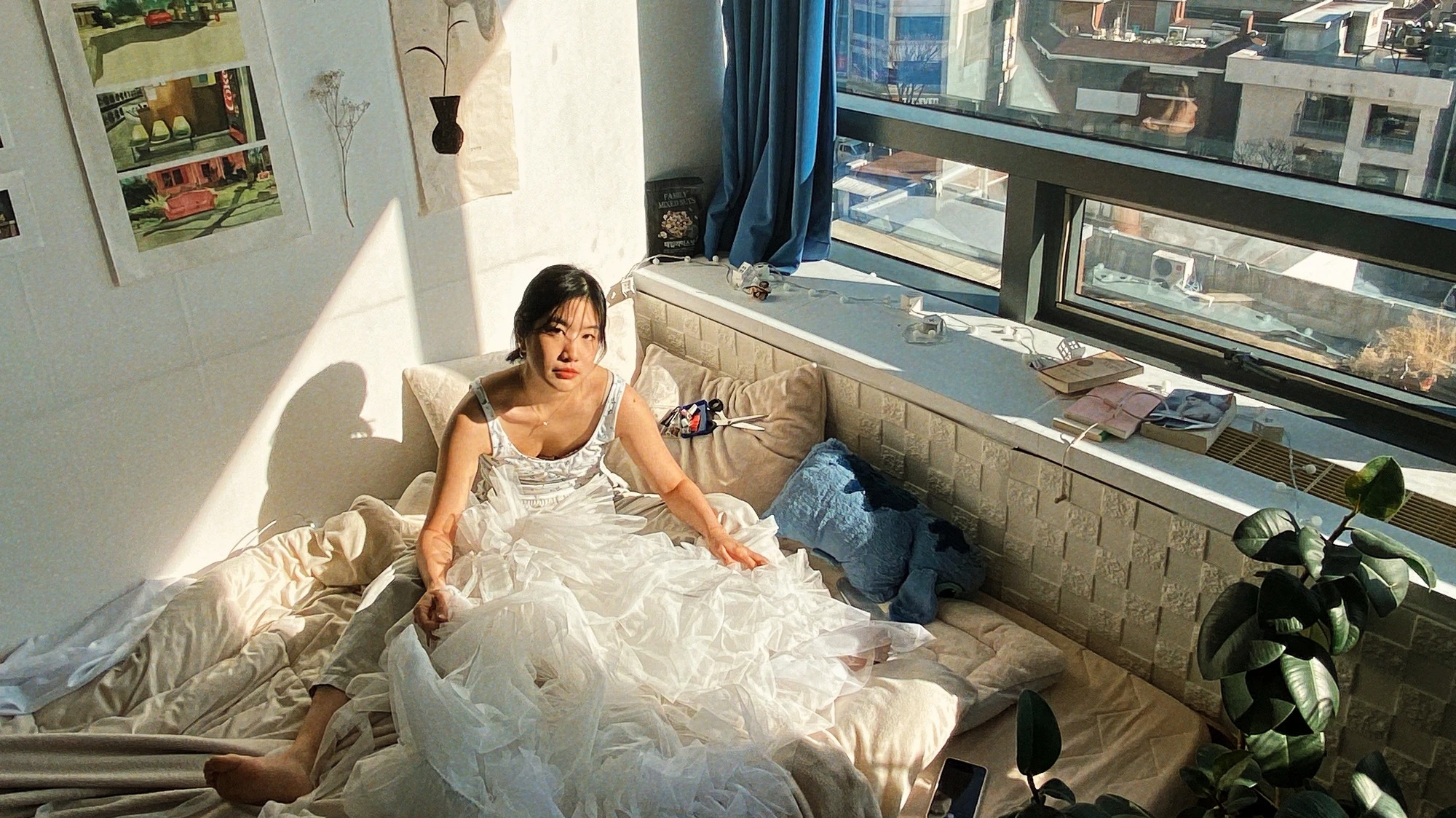 woman making a dress in her bedroom