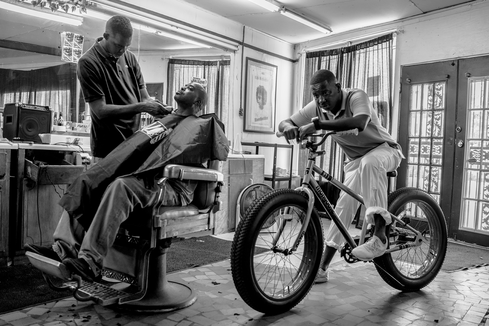 a man on a bike in a barber shop in Robert LeBlanc A New America