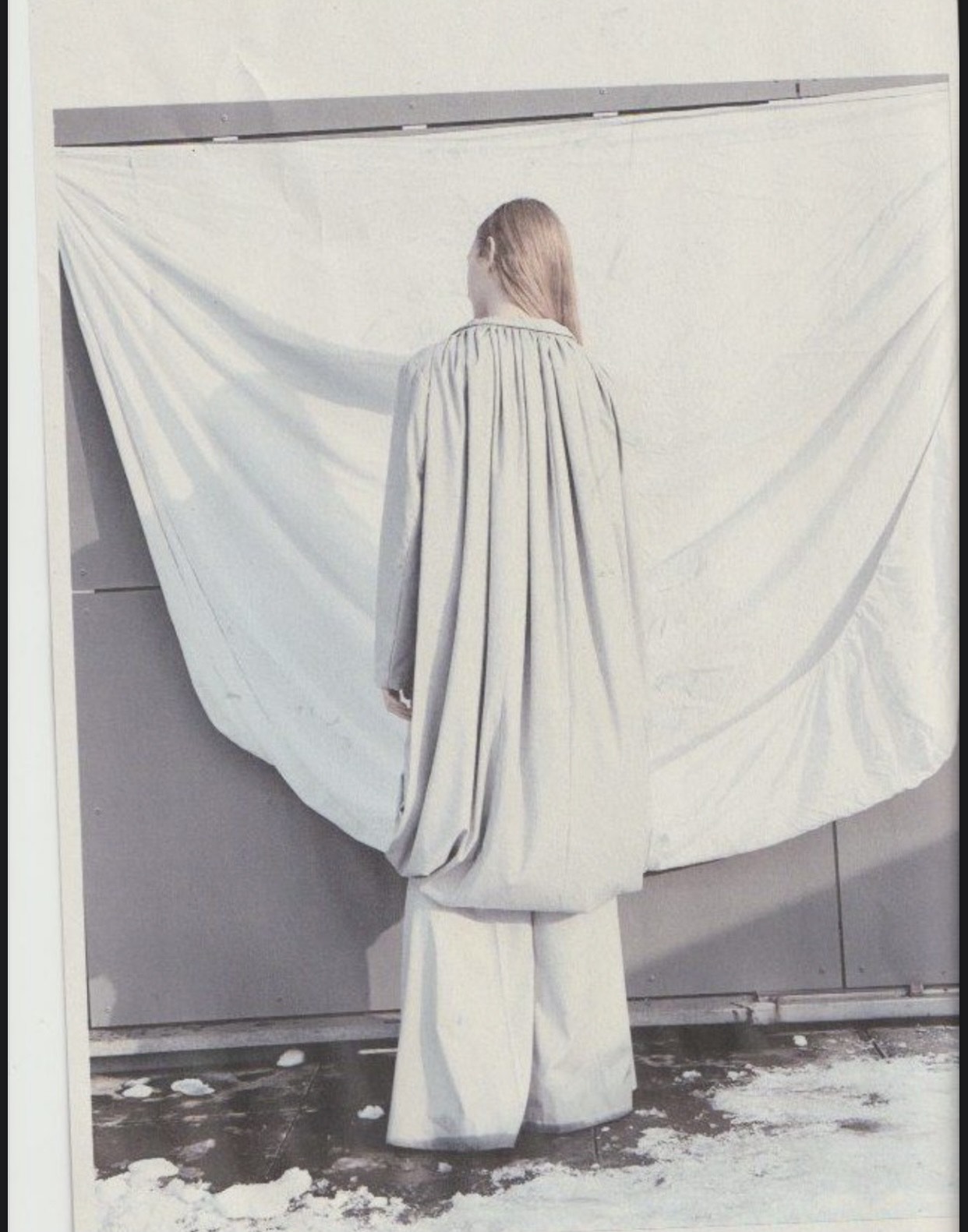 a woman in the snow facing away from the camera