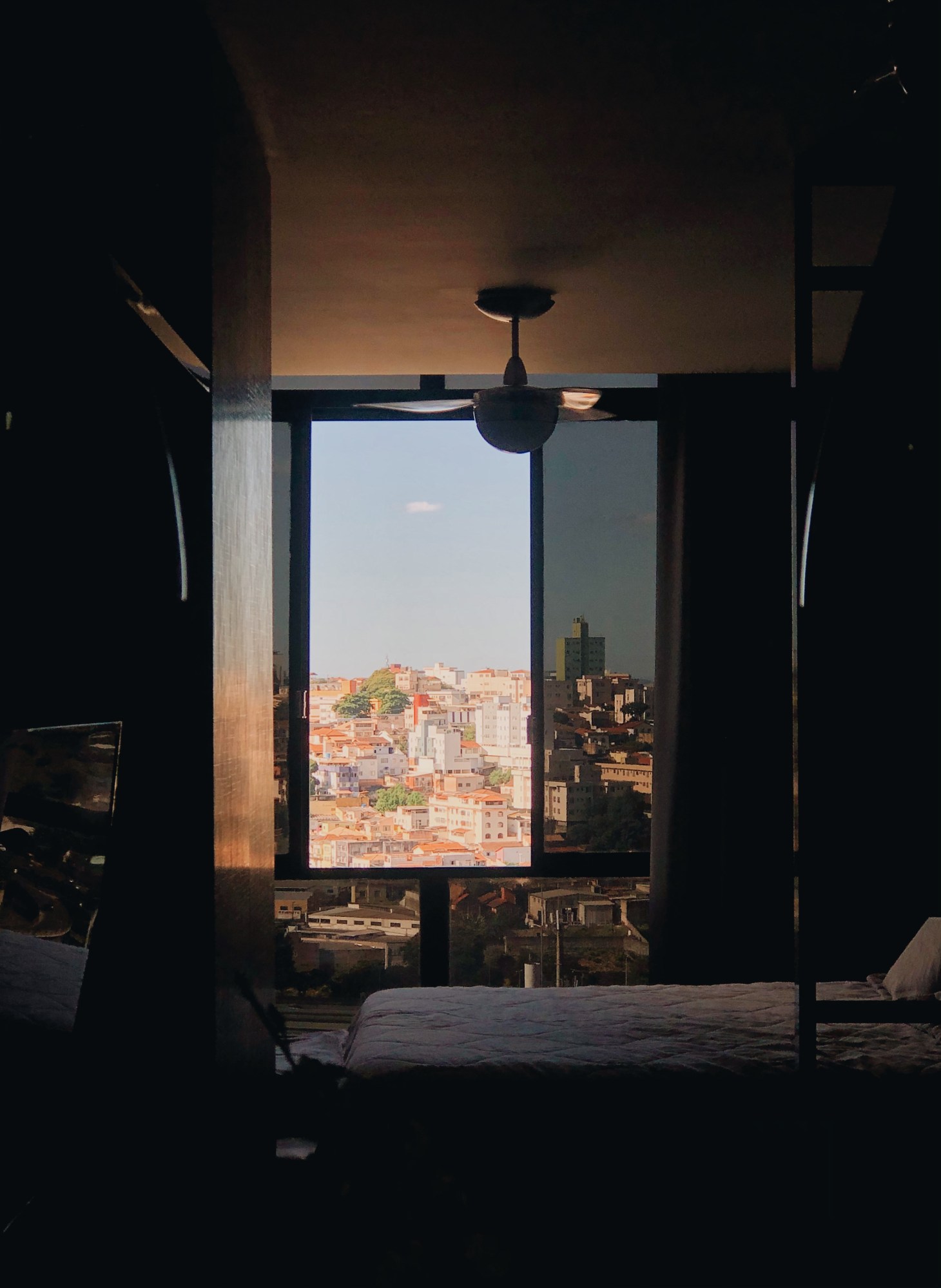 a window looking out onto a brazilian city