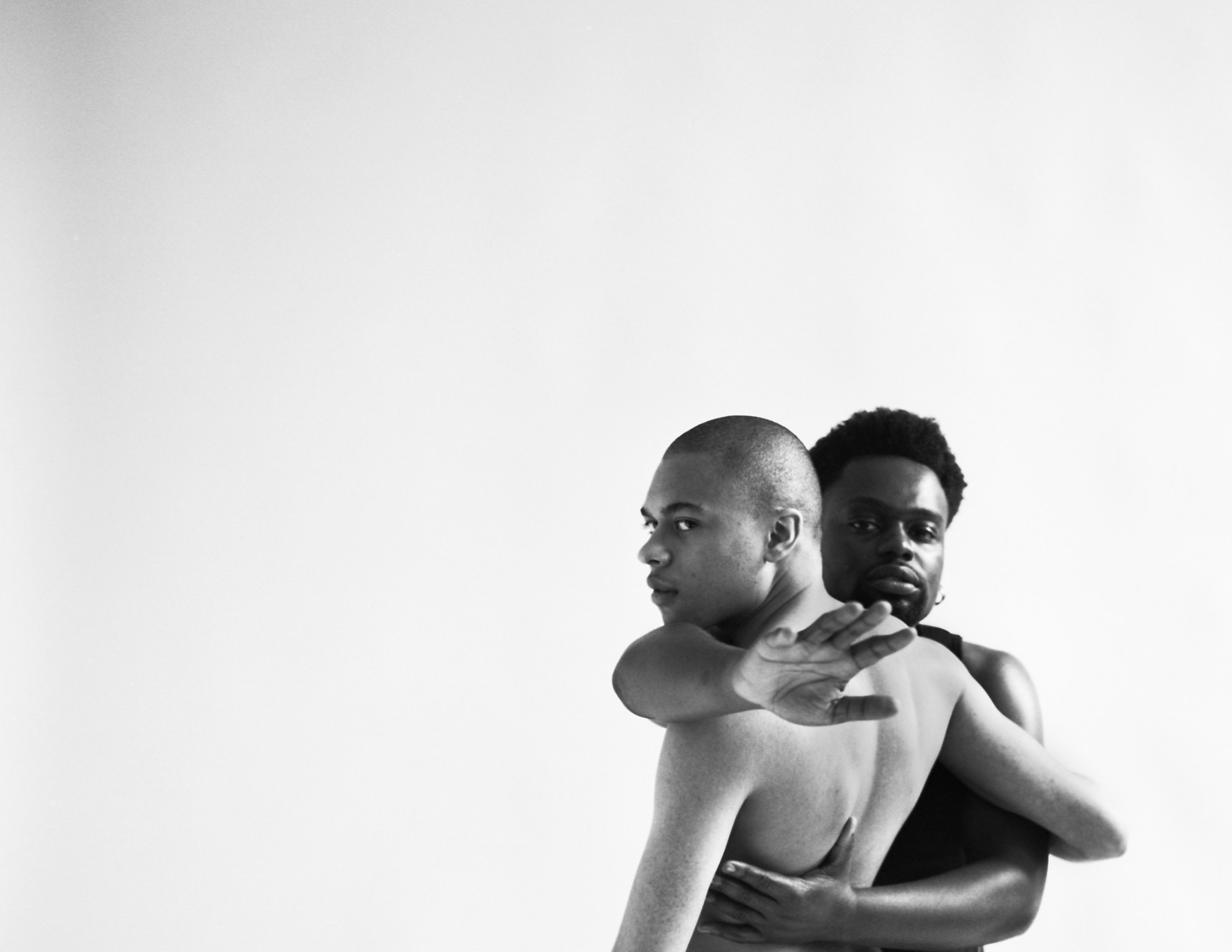 two man holding each other in a photo studio