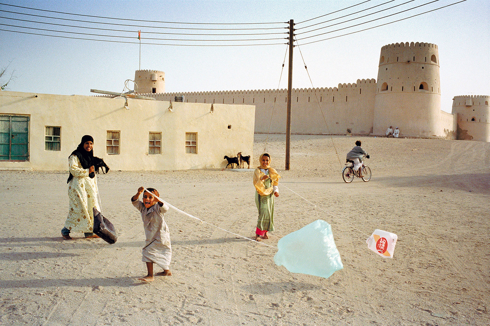 children with kites in oman