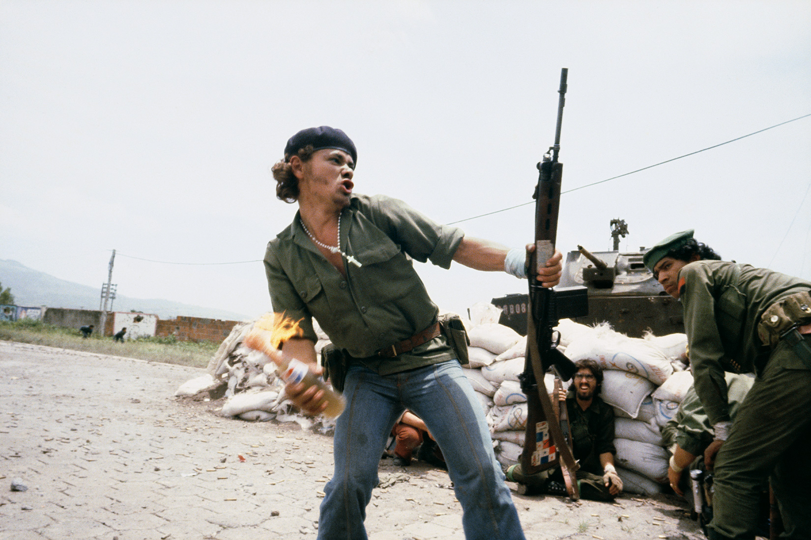 a man throwing a molotov cocktail in nicaragua