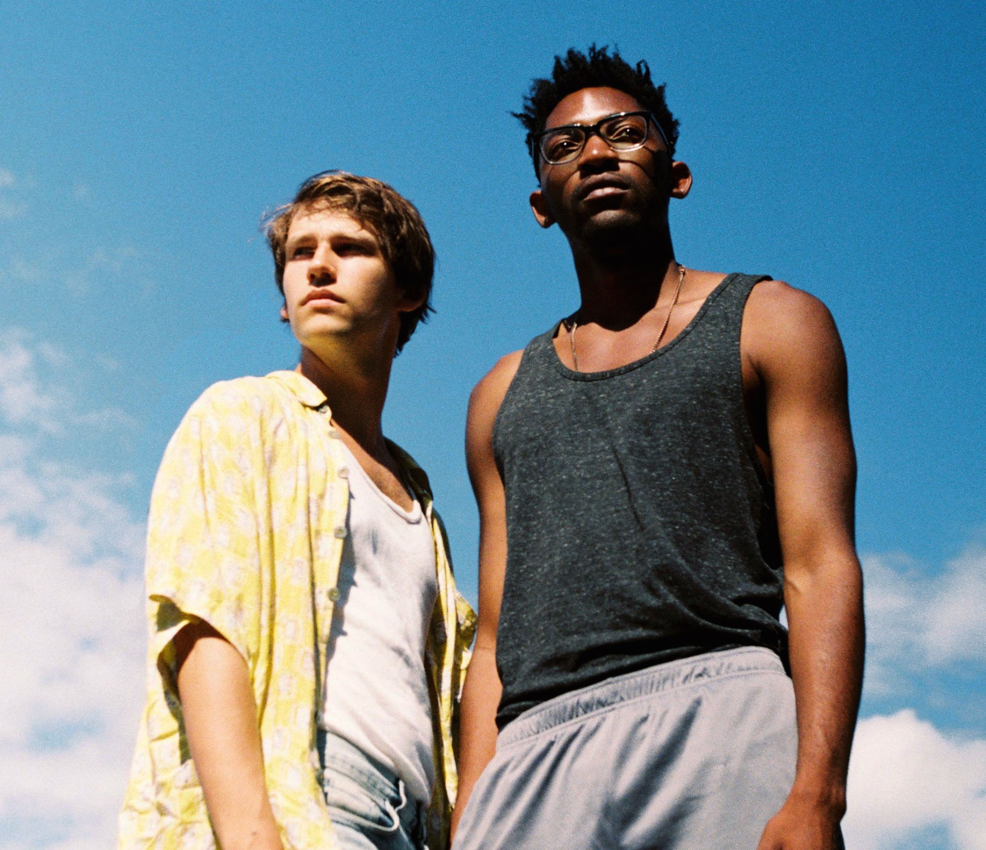 BOY MEETS BOY film: two men standing together with a blue sky backdrop