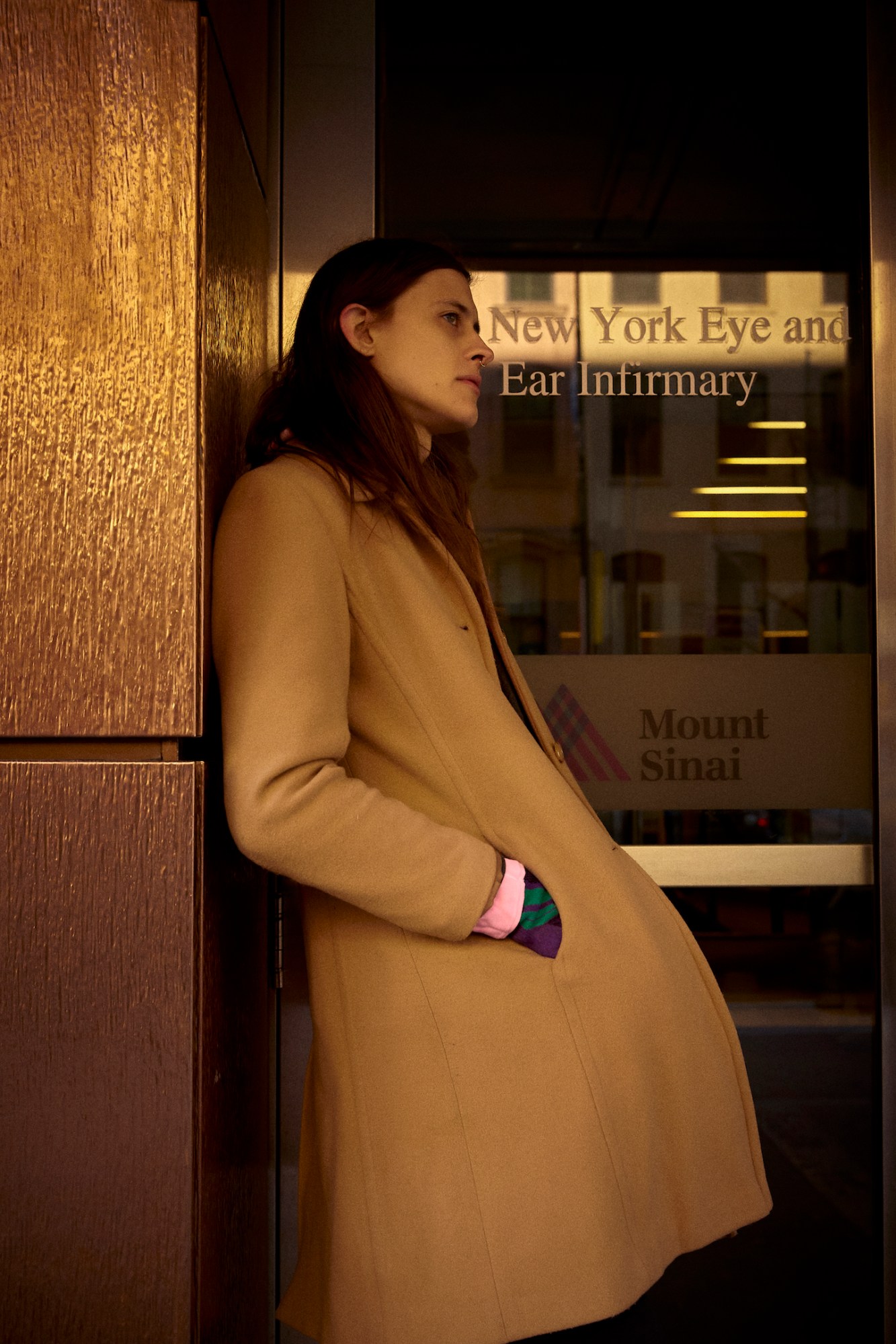 photograph of model Oliver Wight standing outside a doctor's surgery