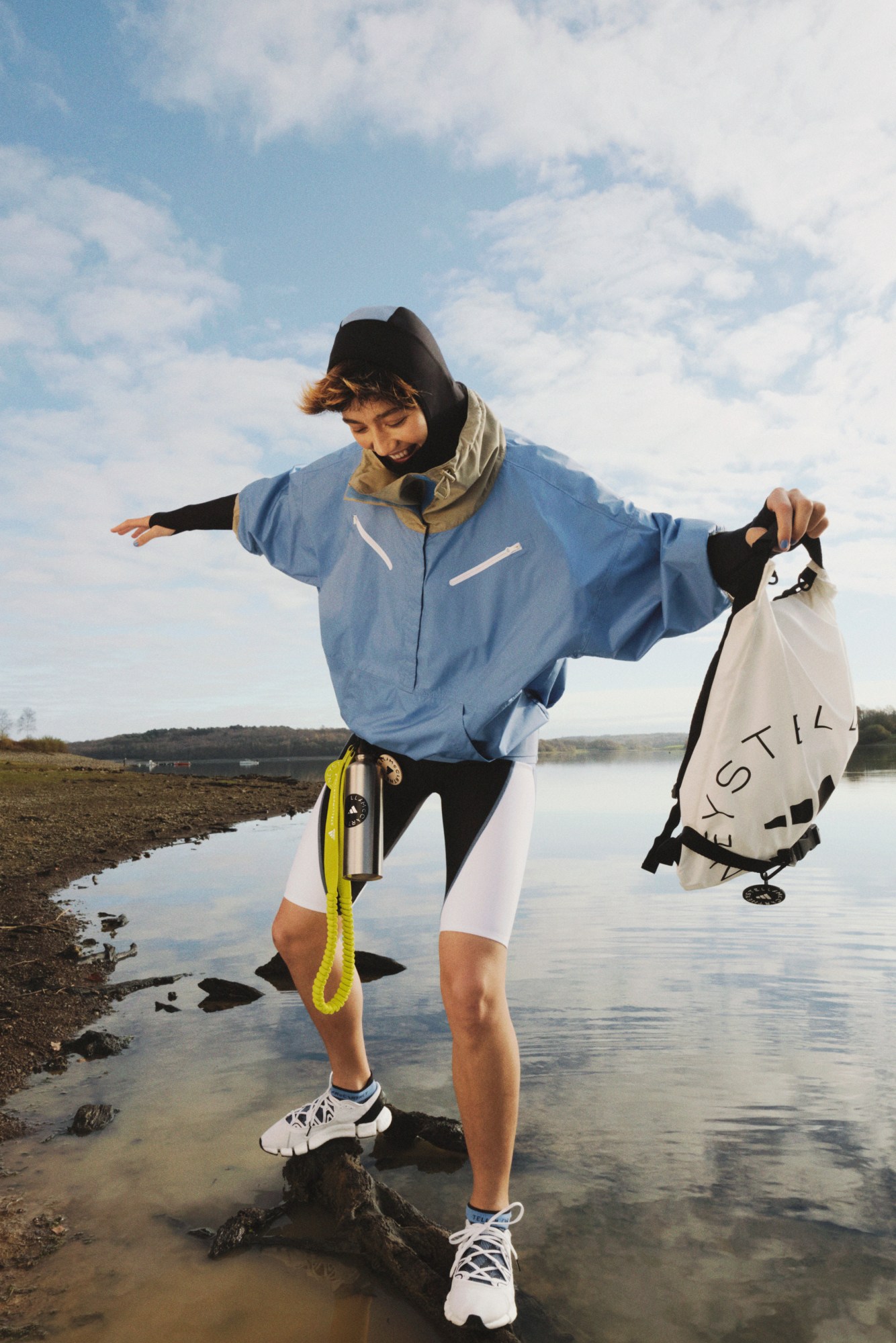 Girl on shore wearing adidas by Stella McCartney SS21 jacket trisuit and shoes