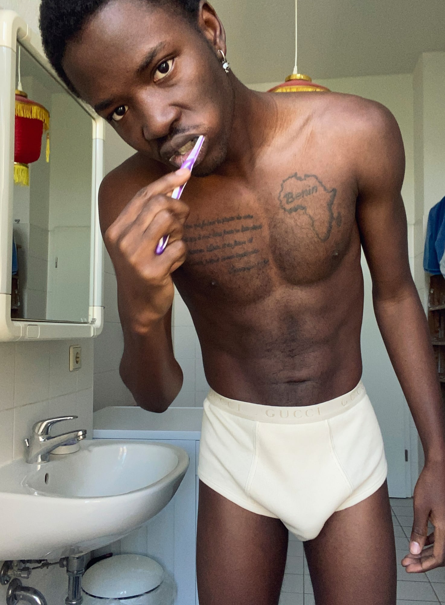 A model in his bathroom brushes his teeth in Gucci underwear for Gucci's AW20 campaign