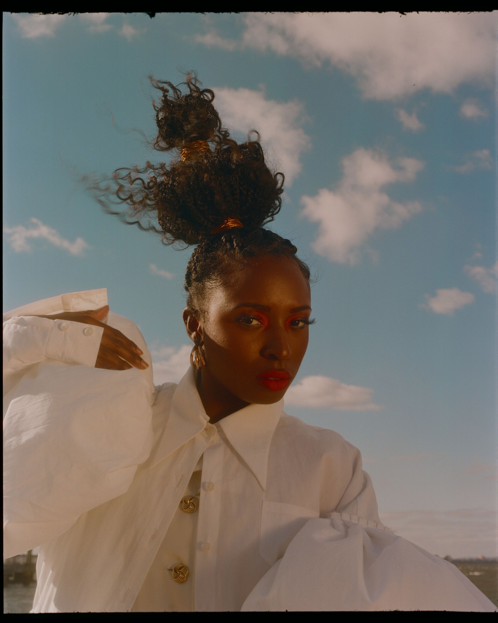 portrait of a woman in a white shirt outside