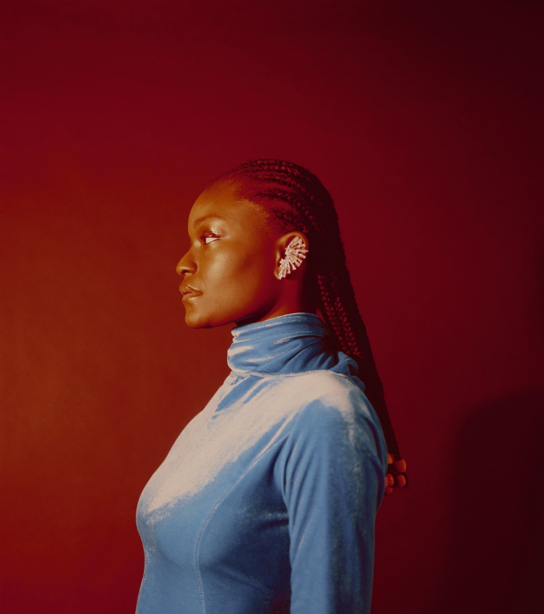 side profile of a woman with braids and cuff earring