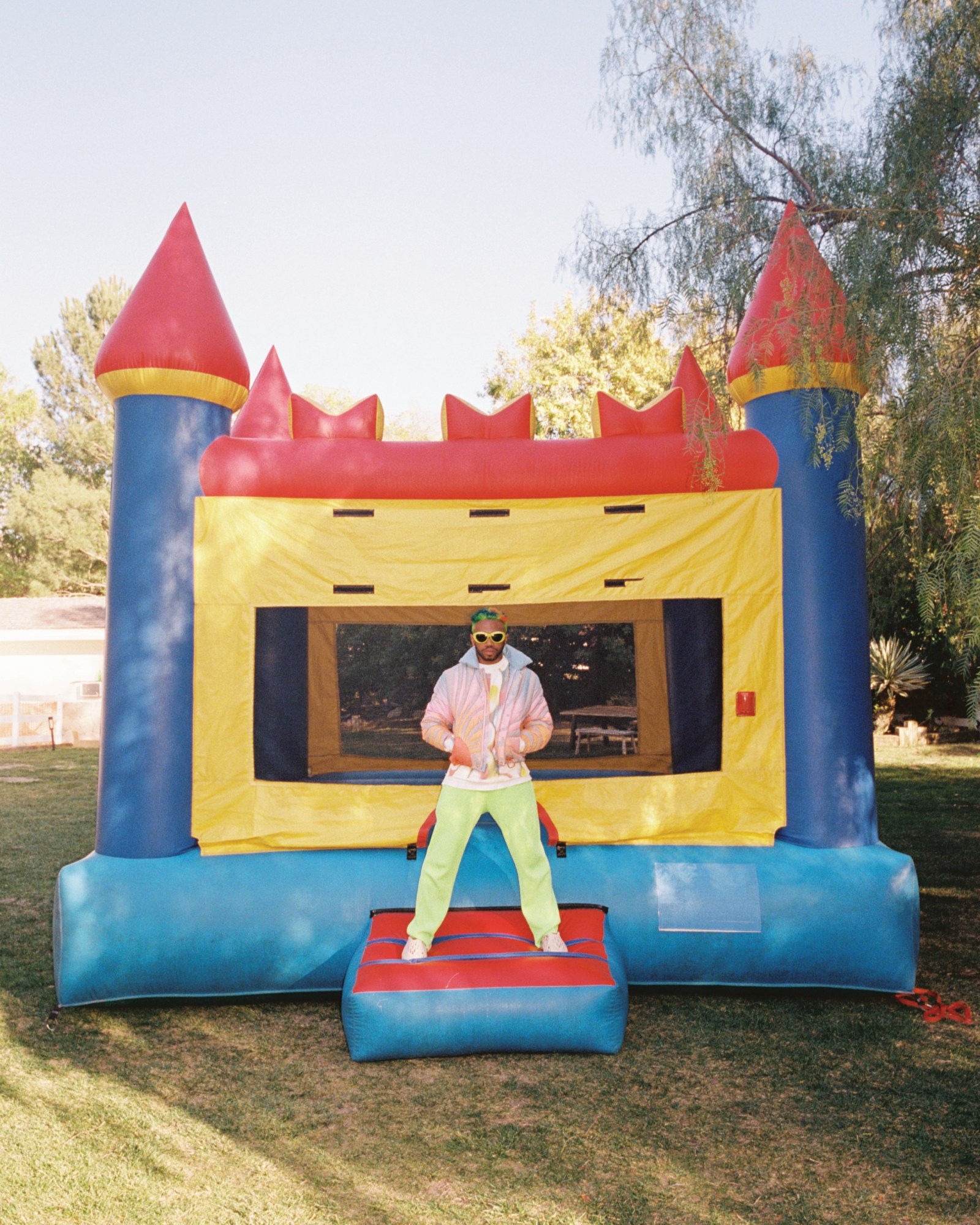 Kevin Abstract standing on a colourful bouncy castle