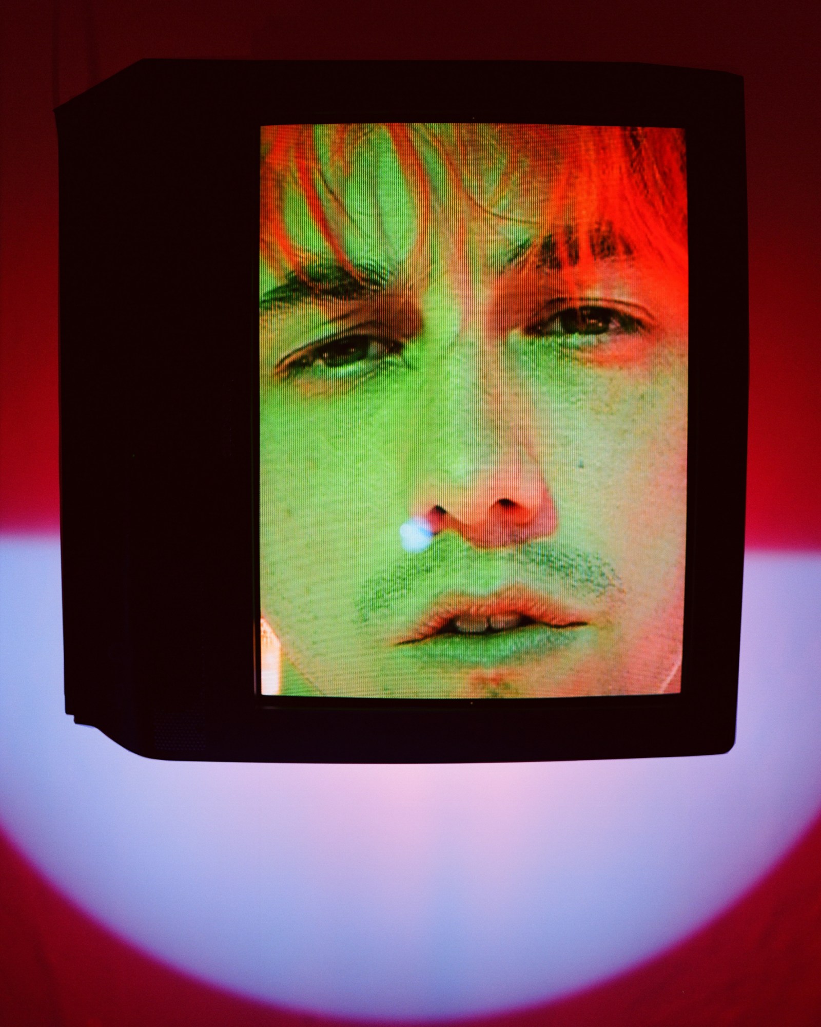 Matt Champion head shot on the front of a black TV-like cube